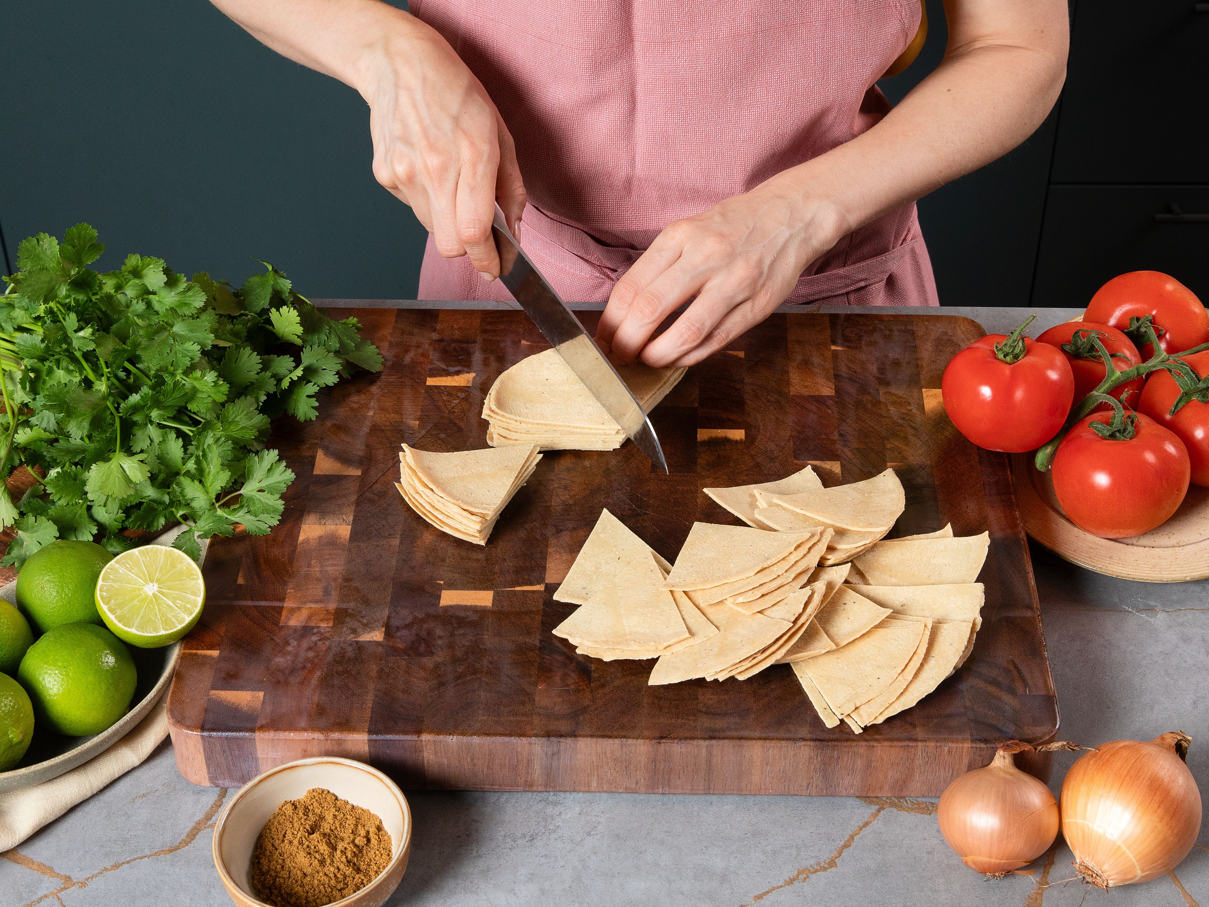 Preheat oven to 200°C/400°F with fan. Cut corn tortillas into even triangles and spread them out on a baking sheet lined with parchment paper. Drizzle with a little olive oil and lightly season with salt. Bake for approx. 10–15 min. until golden brown and crispy.