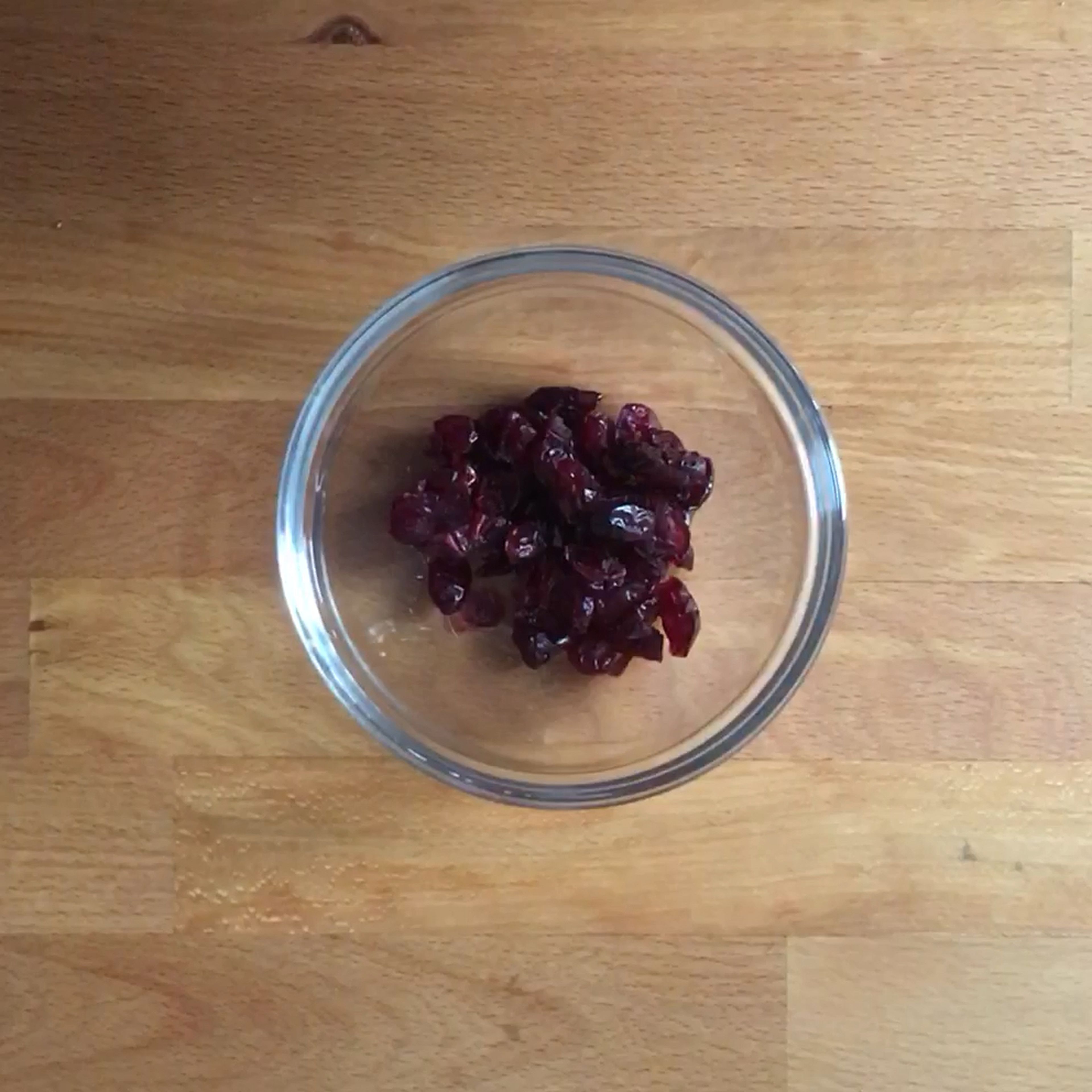 Add the cranberries to a small bowl with the apple cider vinegar. Roughly chop the toasted almonds. Add the lemon juice and olive oil to a large bowl, season with salt and pepper, and mix to combine. Thinly slice apple and add to the dressing, tossing to combine. Pluck the mint leaves from the sprigs and set aside.