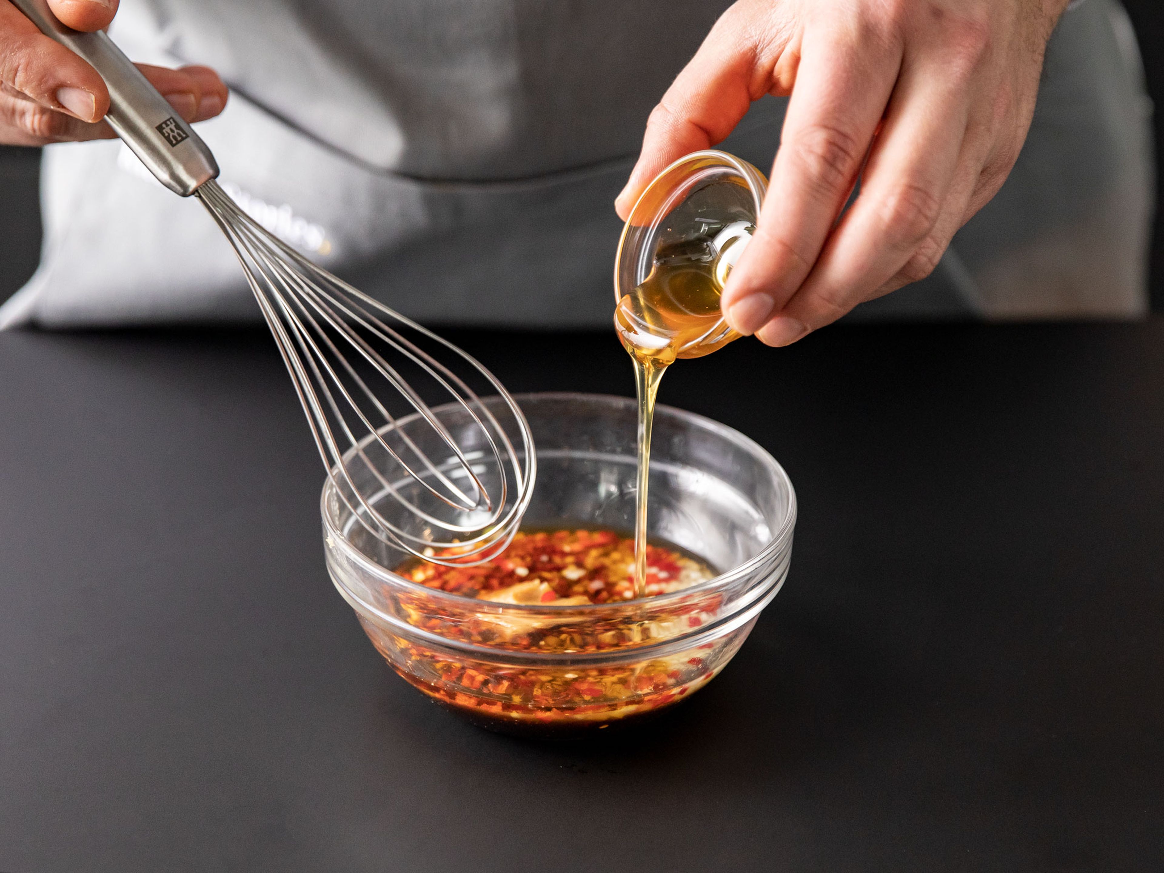 To make the dressing, add miso paste, toasted sesame oil, soy sauce, rice vinegar, and honey to a bowl. Add minced garlic, ginger, and chili and mix well to combine.