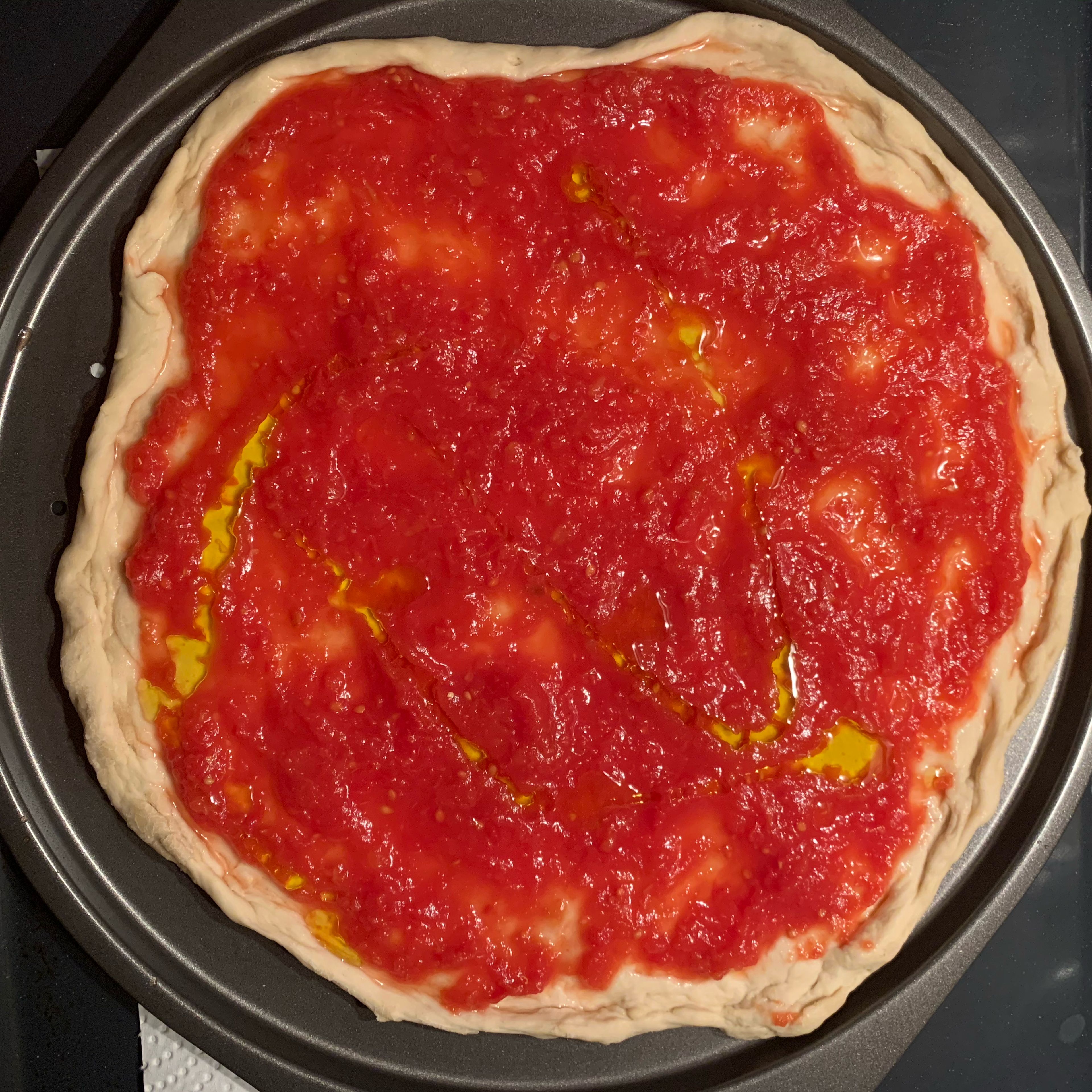 Then add tomato sauce and a bit of olive oil. Bake at 250 degrees for 10 minutes. 