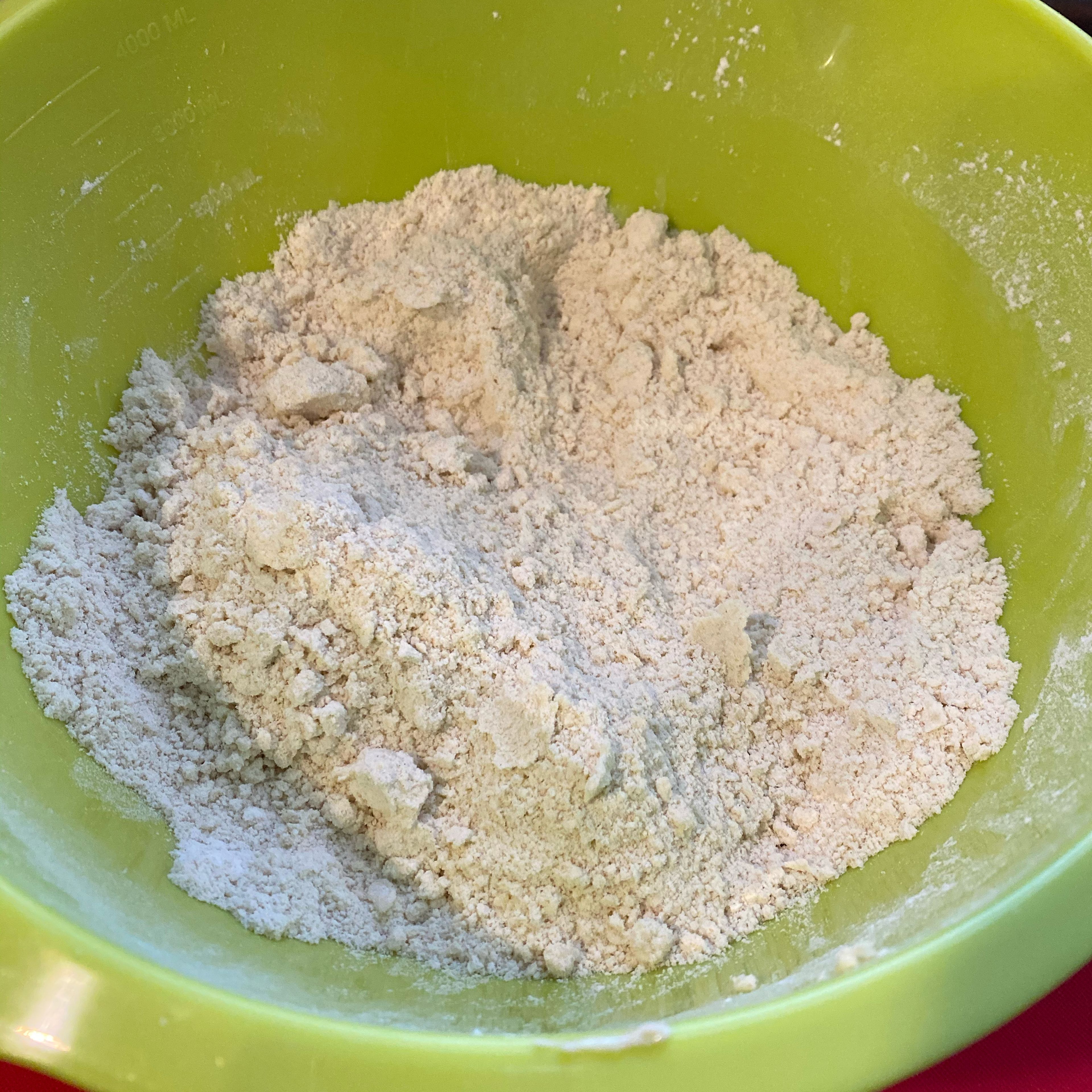 Add the flour, salt, butter, and 1 heaped tsp of baking powder to a big mixing bow and mix everything with your fingers until it resembles fine breadcrumbs.