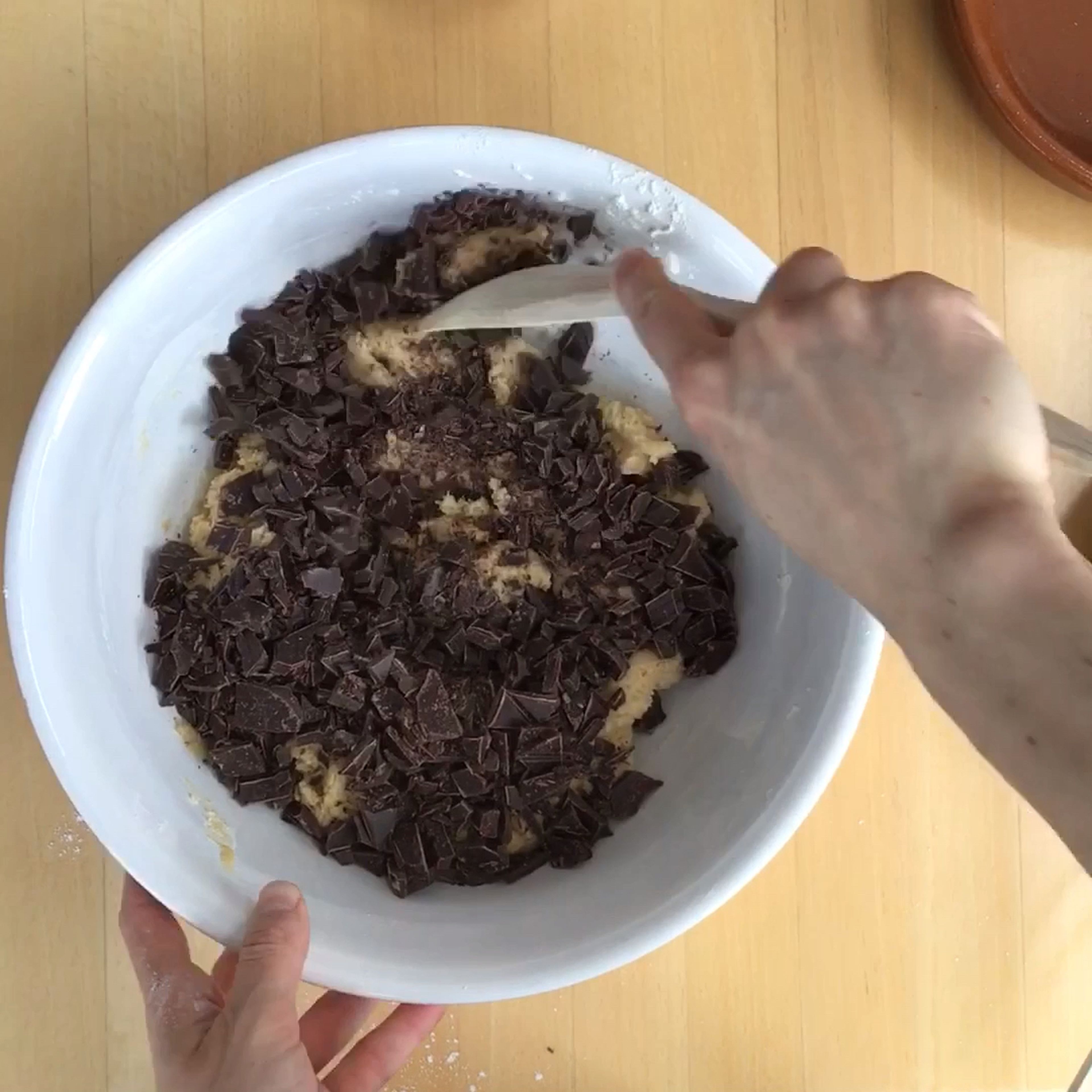 Add butter, raw sugar, and sugar to a large bowl. Beat for approx. 3 min., or until combined. Add vanilla extract and egg, then keep beating until the mixture is light and fluffy. Stir in flour mixture until it's just incorporated. Use a rubber spatula to fold in chocolate chips (or chopped dark chocolate with at least 70% cocoa).