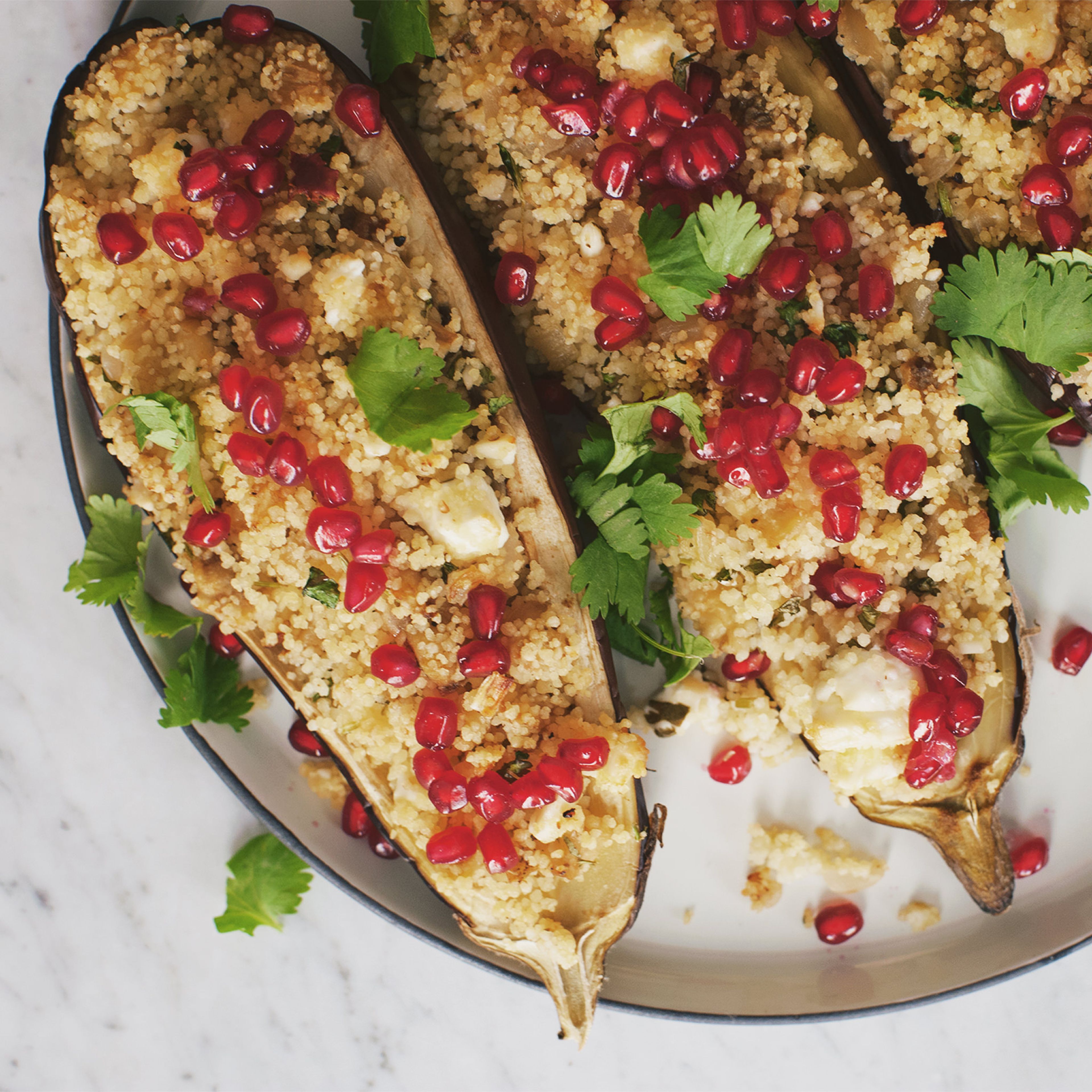 Pomegranate and couscous stuffed eggplant