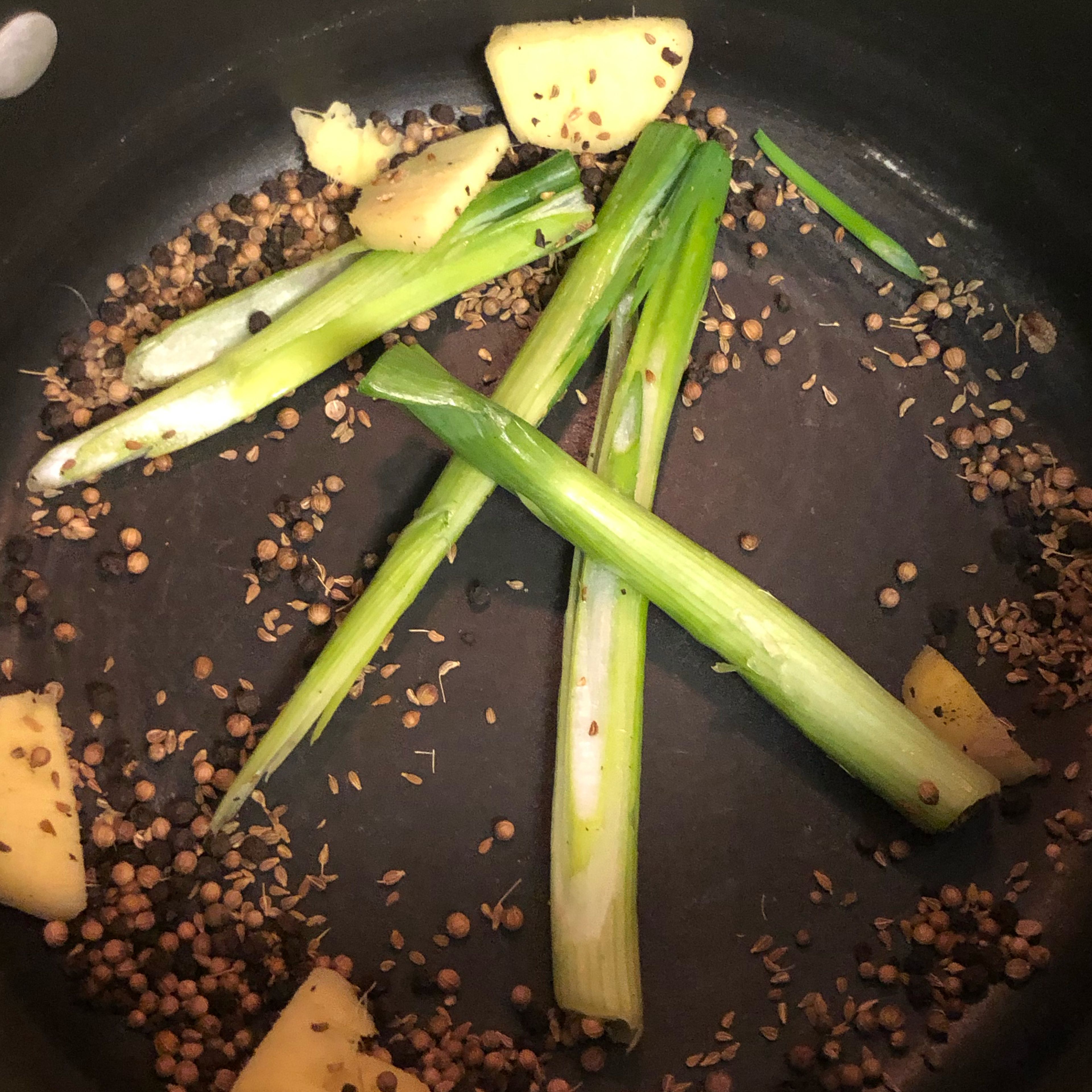 Peel and slice ginger. Trim the tips and ends of the green onion. Then split them. Save tips for serving! Add the ginger and green onion into the pot and let cook for 3 minutes. Pay attention to the smell, you don’t want it to burn.