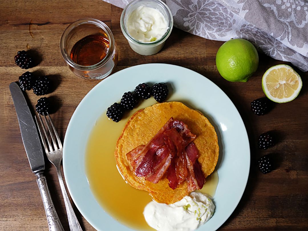 Pumpkin pancakes with bacon and blackberries