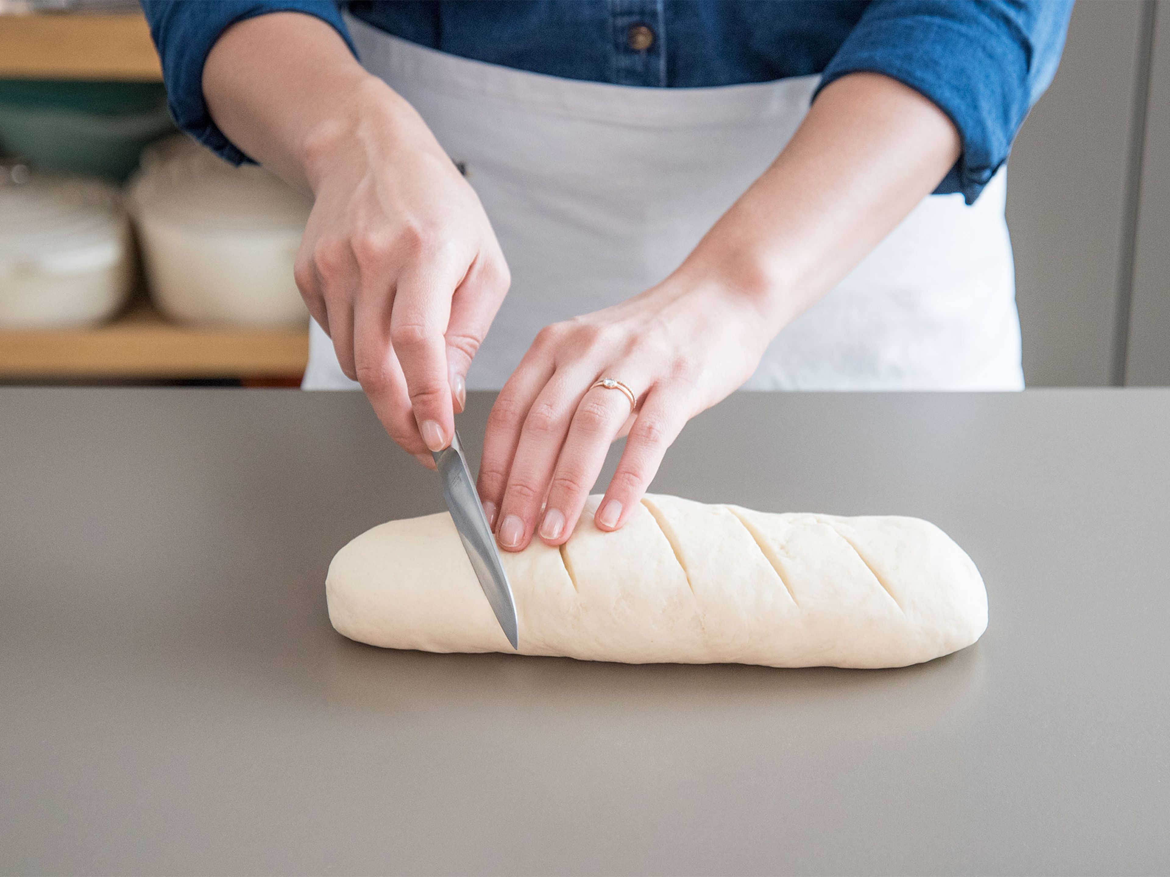 Briefly knead dough, then form into a 25-cm/10-in. loaf. Transfer to a cutting board and score loaf diagonally several times (approx. 1-cm/0.4-in. deep). Wrap bread and cutting board in plastic wrap, cover with a damp kitchen towel, and freeze for at least 12 hrs.