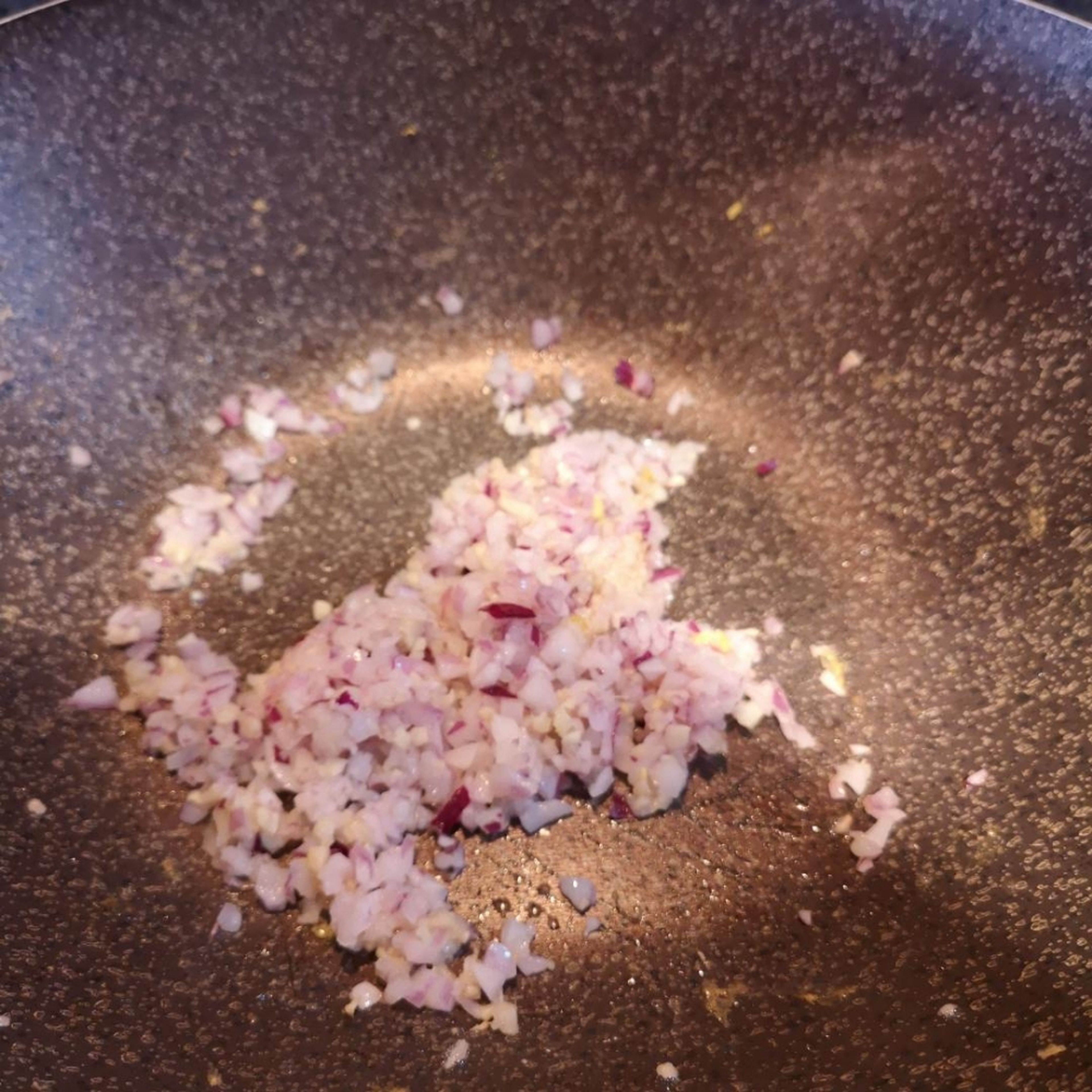 add chopped red onion and stir fry with garlic and ginger