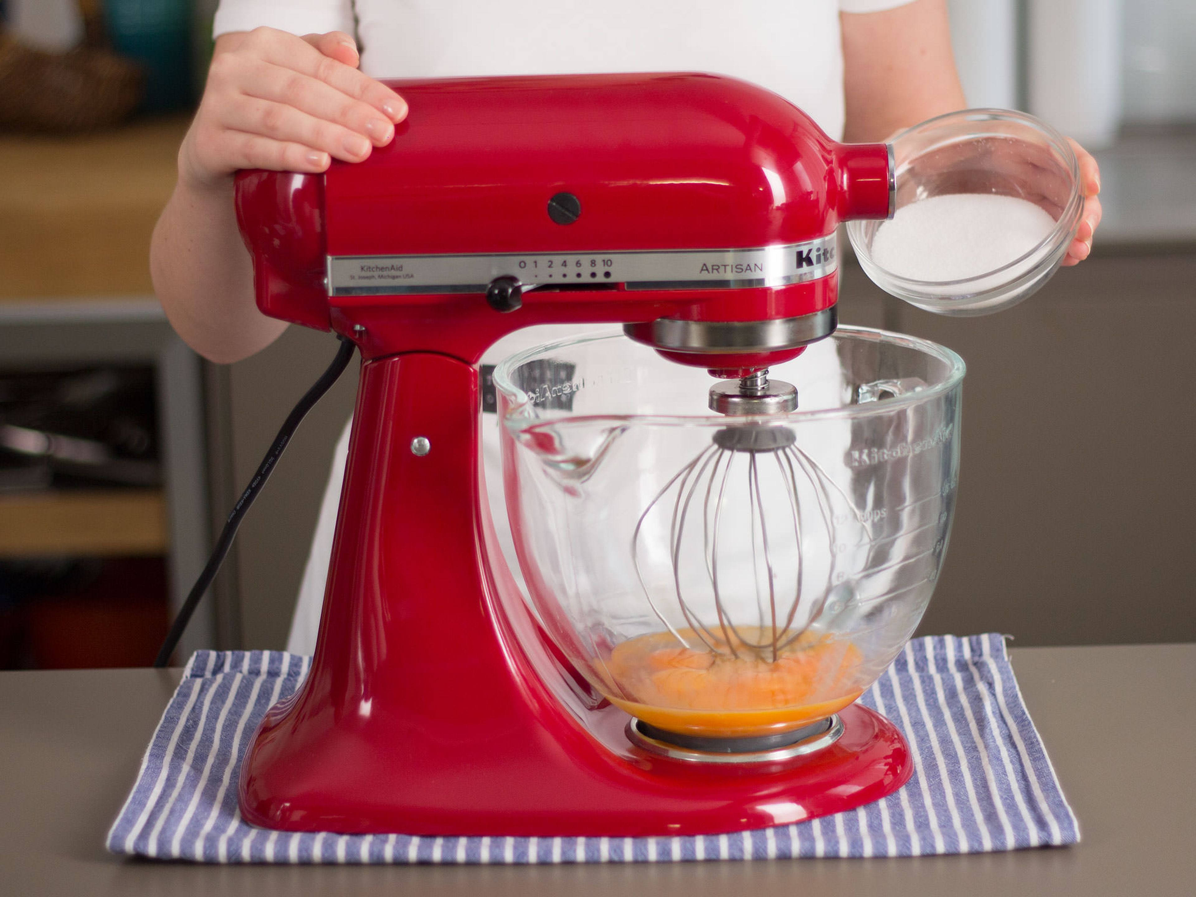 In a stand mixer, beat together egg yolks, eggs, and sugar until stiff peaks form.