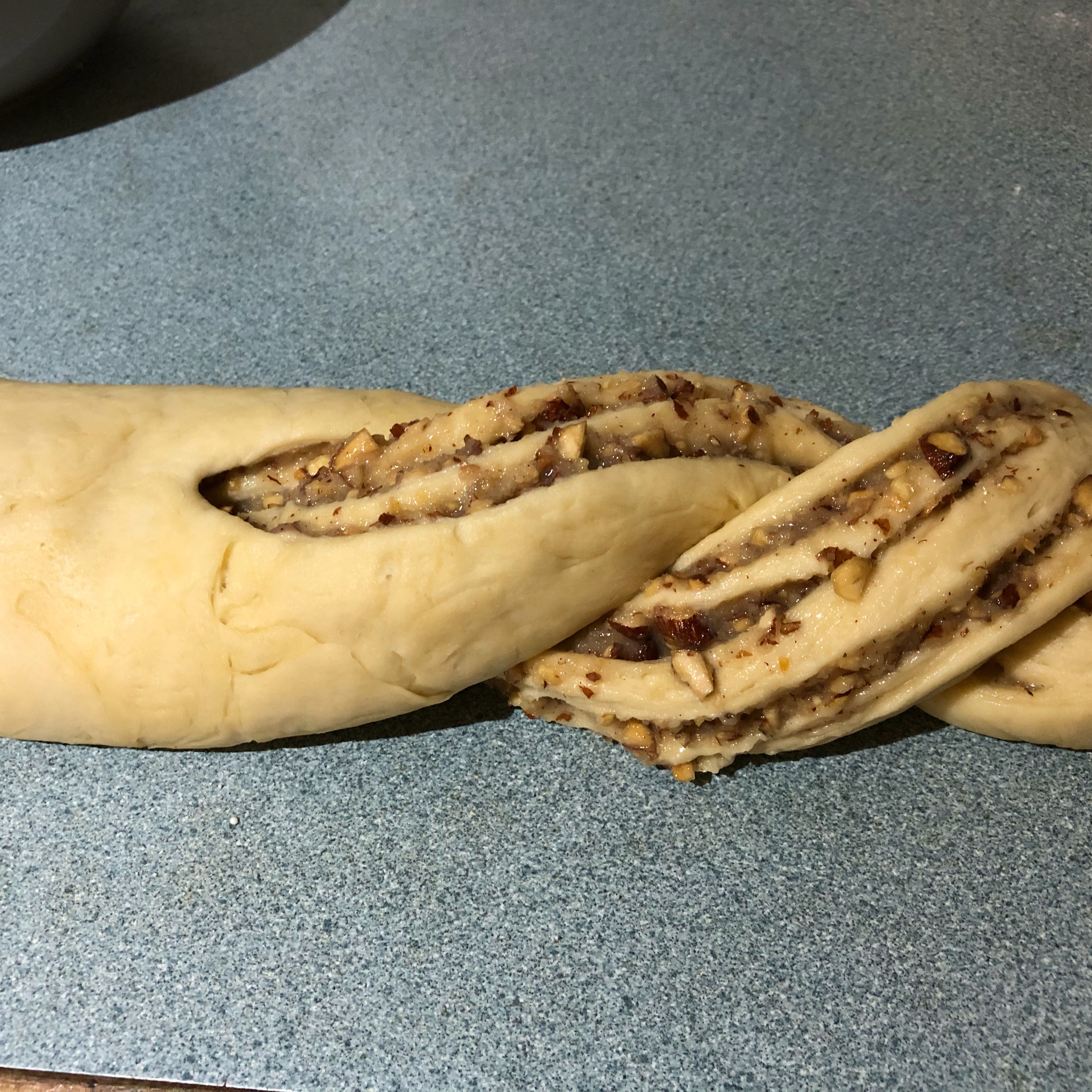 Roll up the dough from the long edge to form a log. Cut into halves from the middle to the end and wrap two halves around reach other.