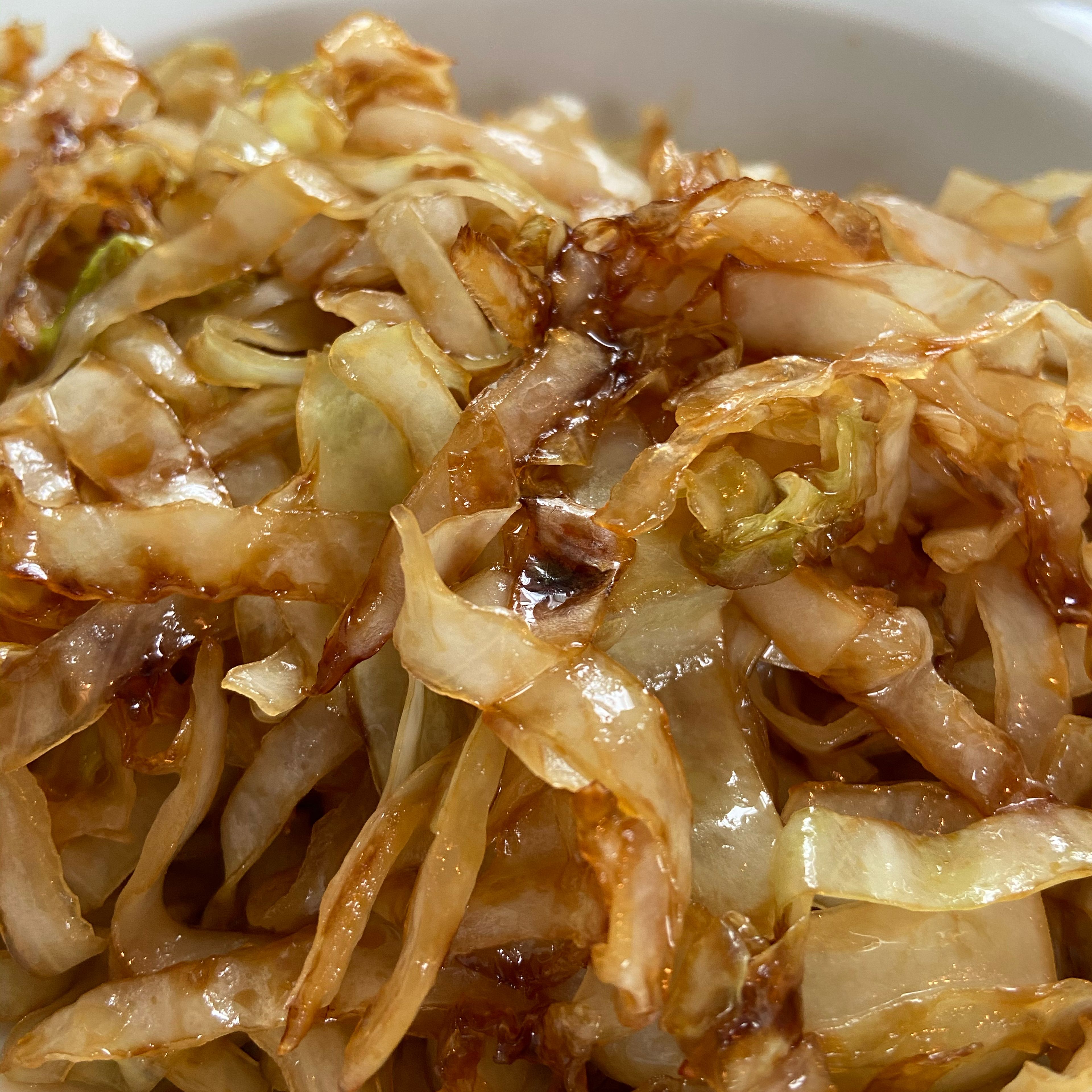 In portions caramelise 1 tbsp of lard with one-third of the chopped cabbage and one-third of the sliced onions until nice and dark.