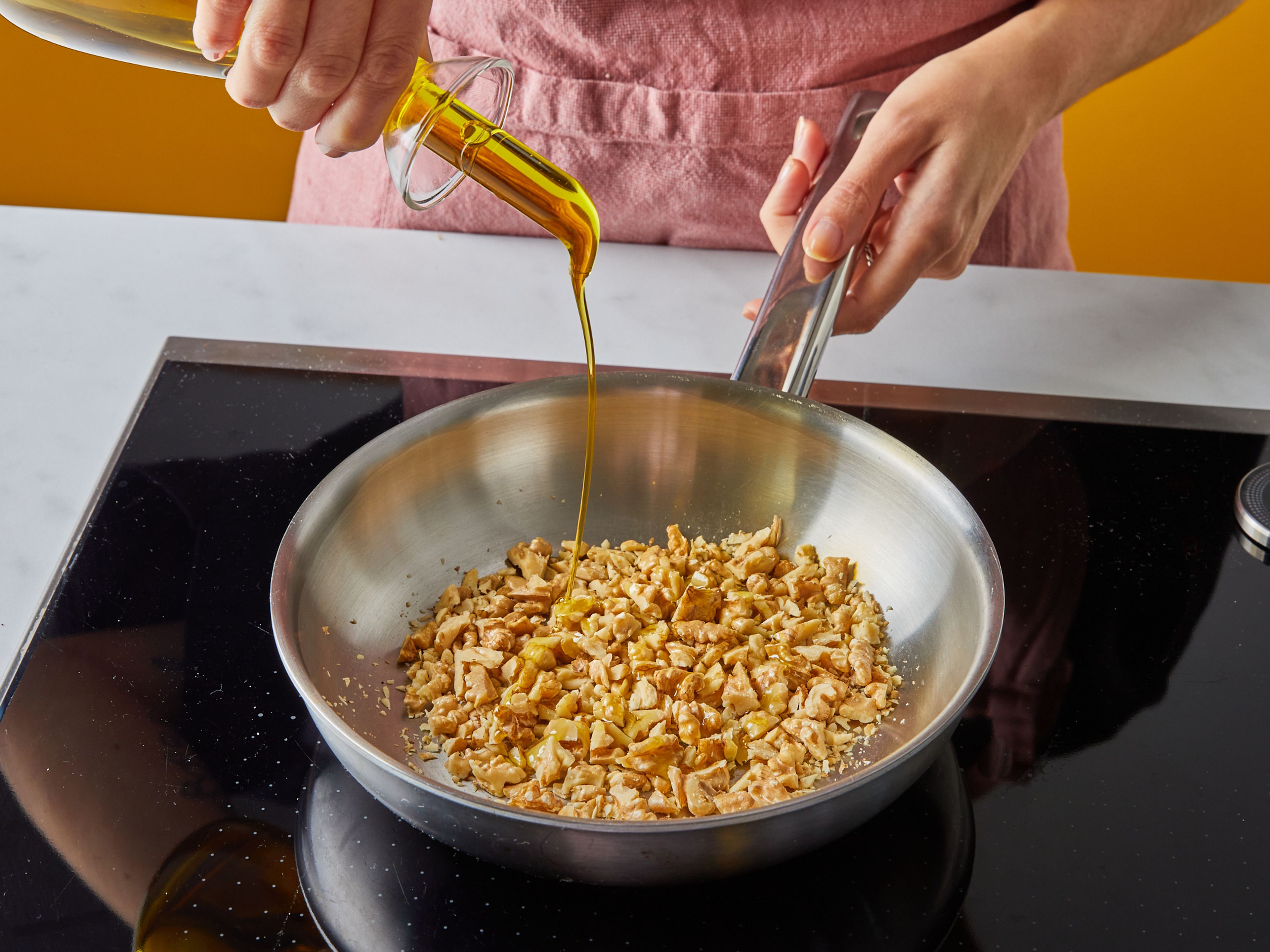 Transfer walnuts to a small, dry frying pan over medium heat. Toss with a little bit of olive oil and toast, stirring often, until golden brown and fragrant, approx. 8 min. Remove and set aside. Wipe out the pan and return to medium heat.
