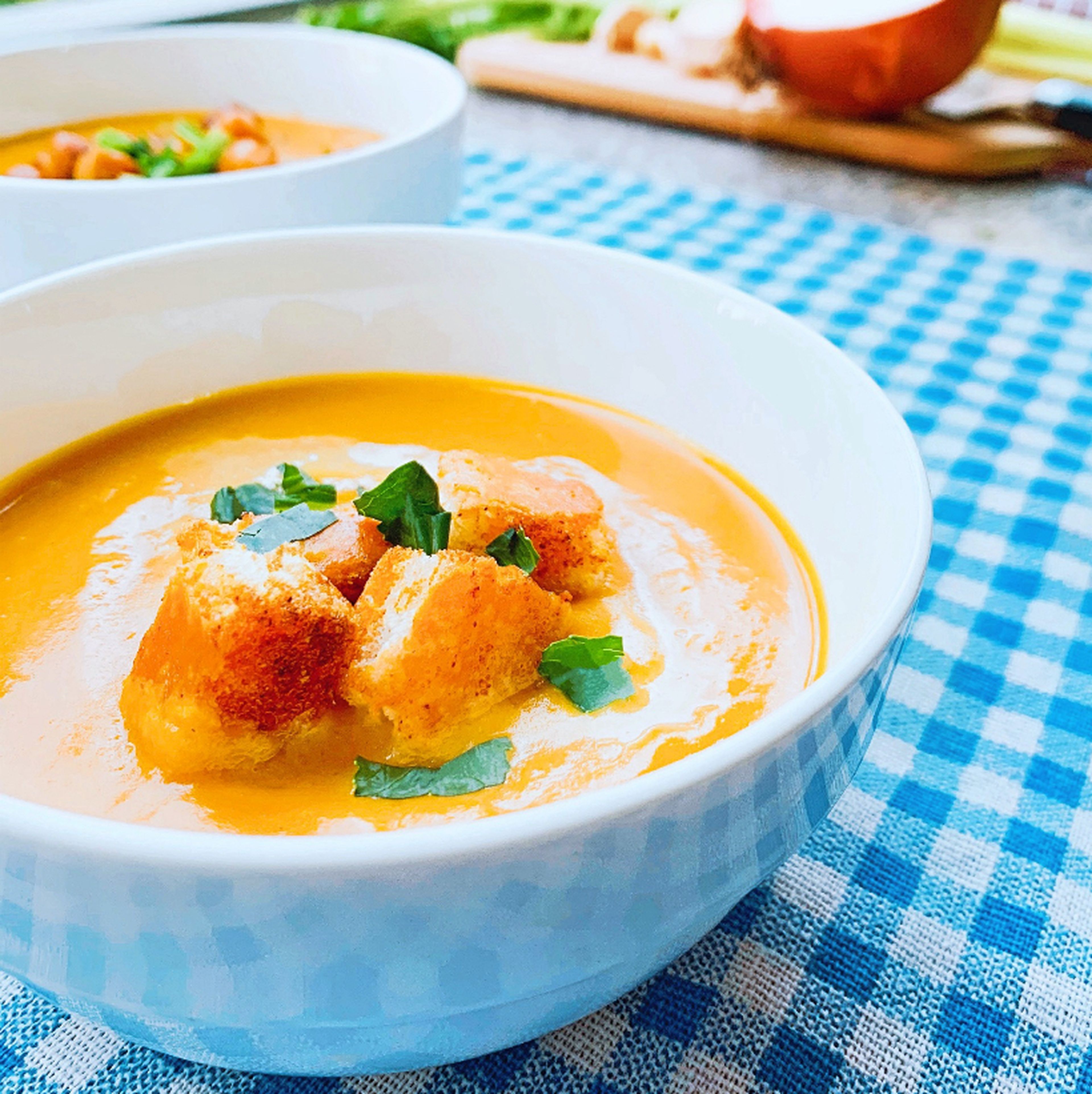 Use a soup spoon to scoop the warm soup into bowls. Top with crunchy croutons and chickpeas and enjoy!