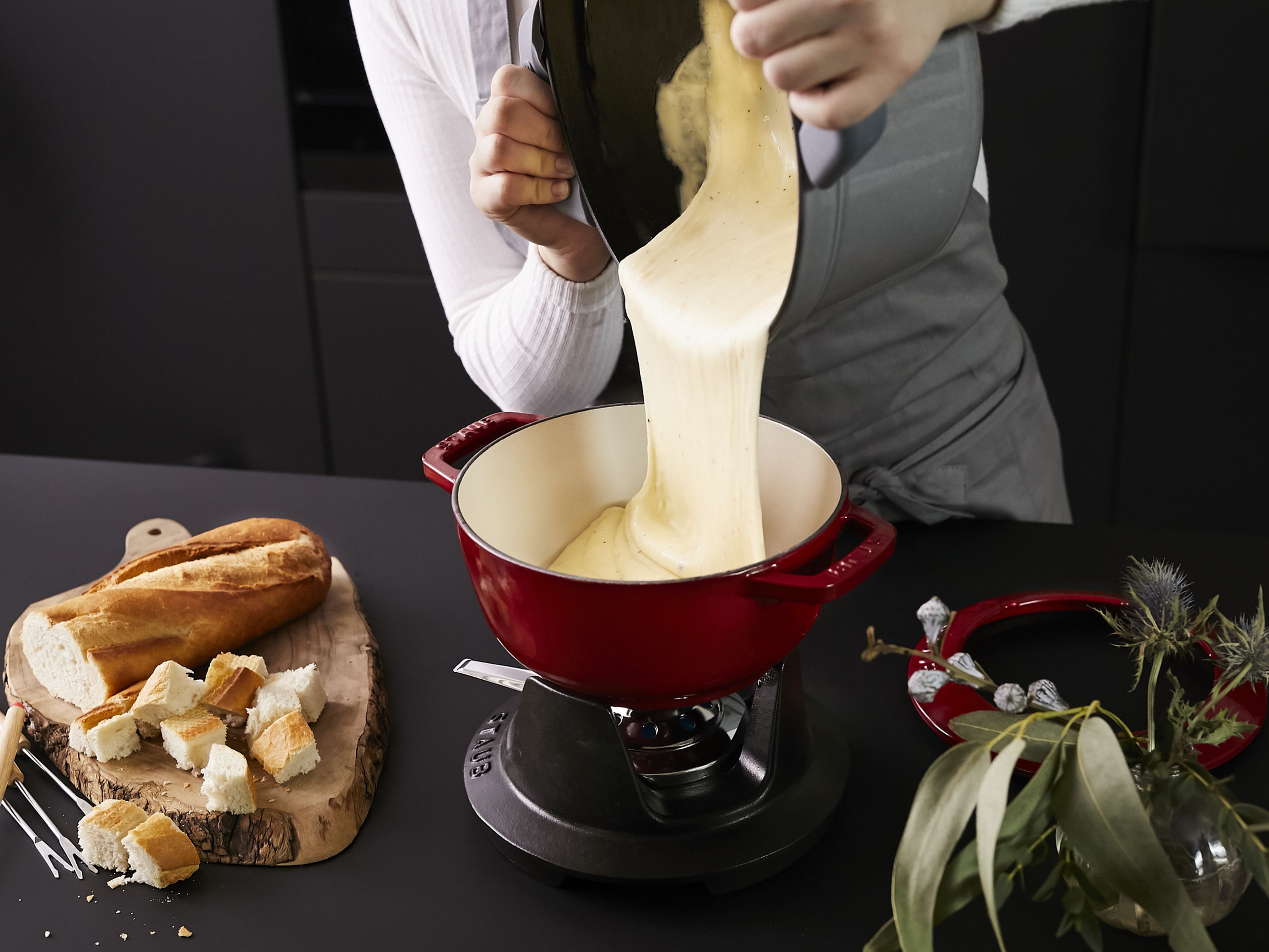 Serve cheese fondue with a baguette, pickles or other sides. Enjoy!