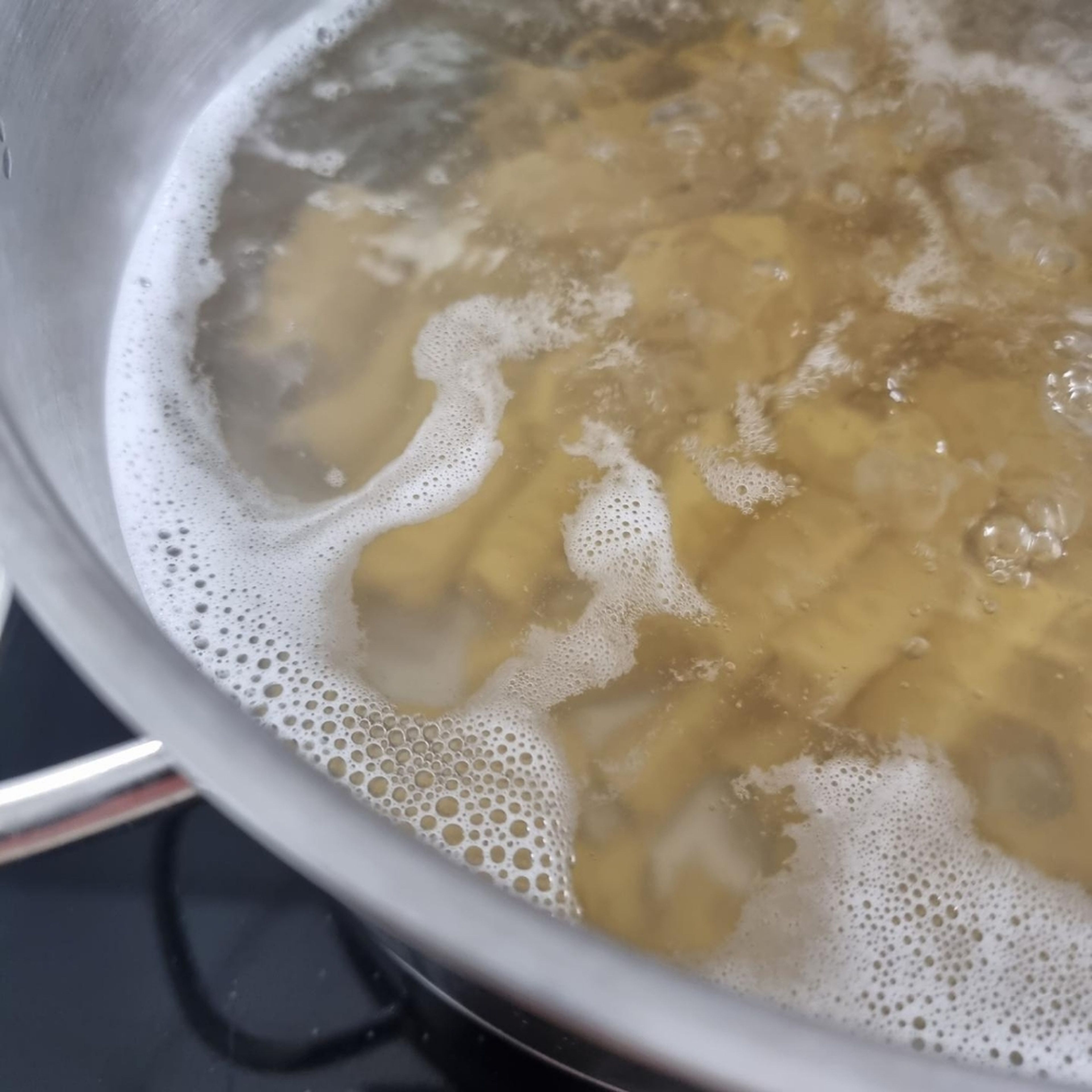 In a pot, bring water to a boil and add salt. Cook the pasta according to package instructions.