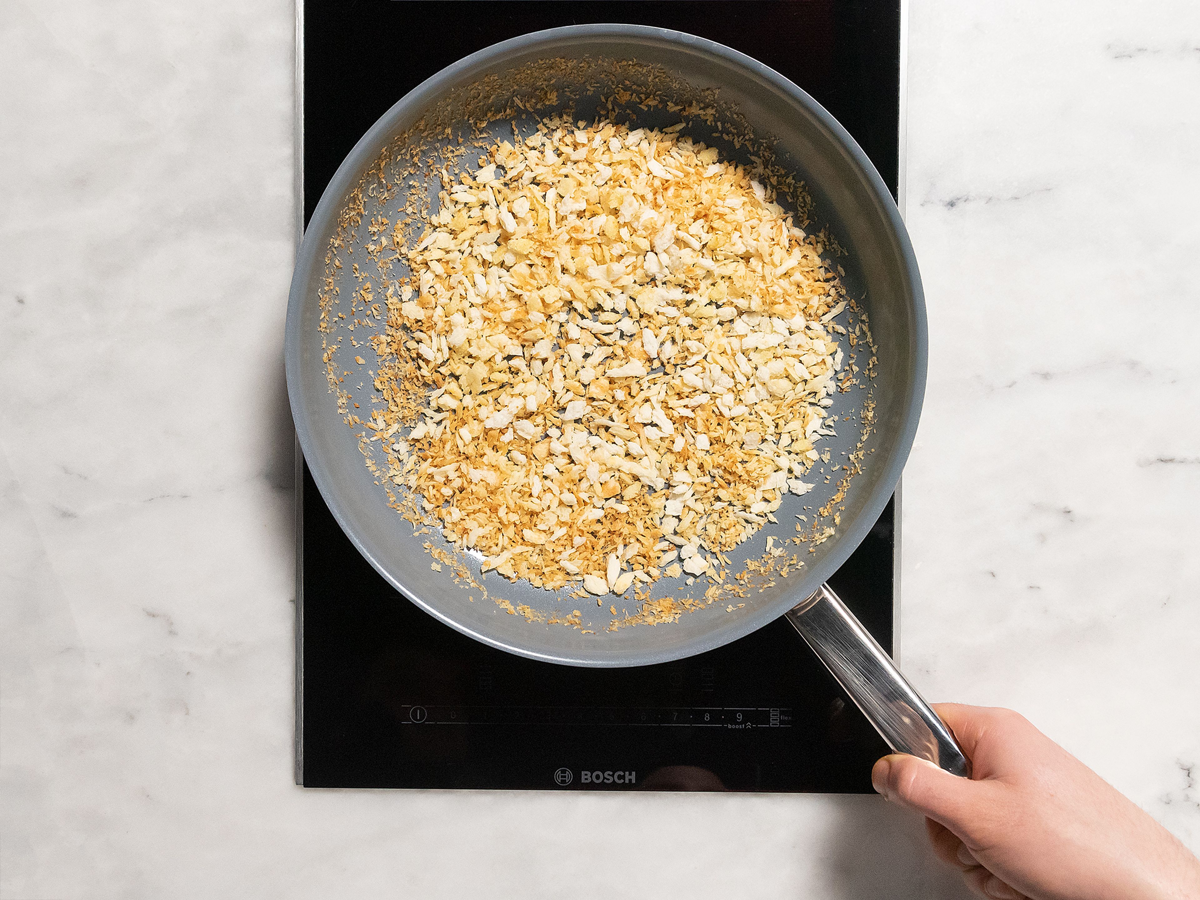 Heat a large frying pan with half the olive oil over medium-high heat. Toast the panko until crunchy and brown. Remove panko from heat and set aside.