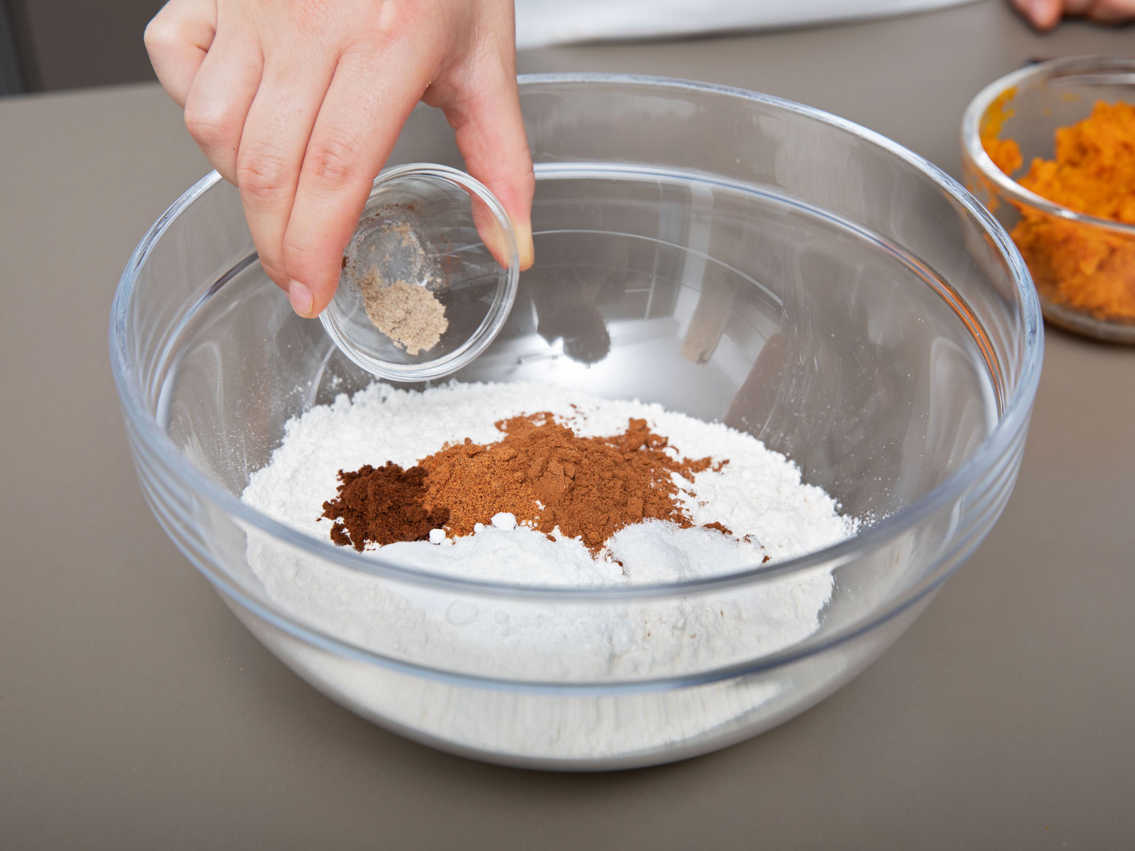 Reduce oven temperature to 175°C/350°F. Chop walnuts and set aside. Add flour, ground cinnamon, nutmeg, cloves, cardamom, baking powder, baking soda, and salt to a bowl and stir to combine.