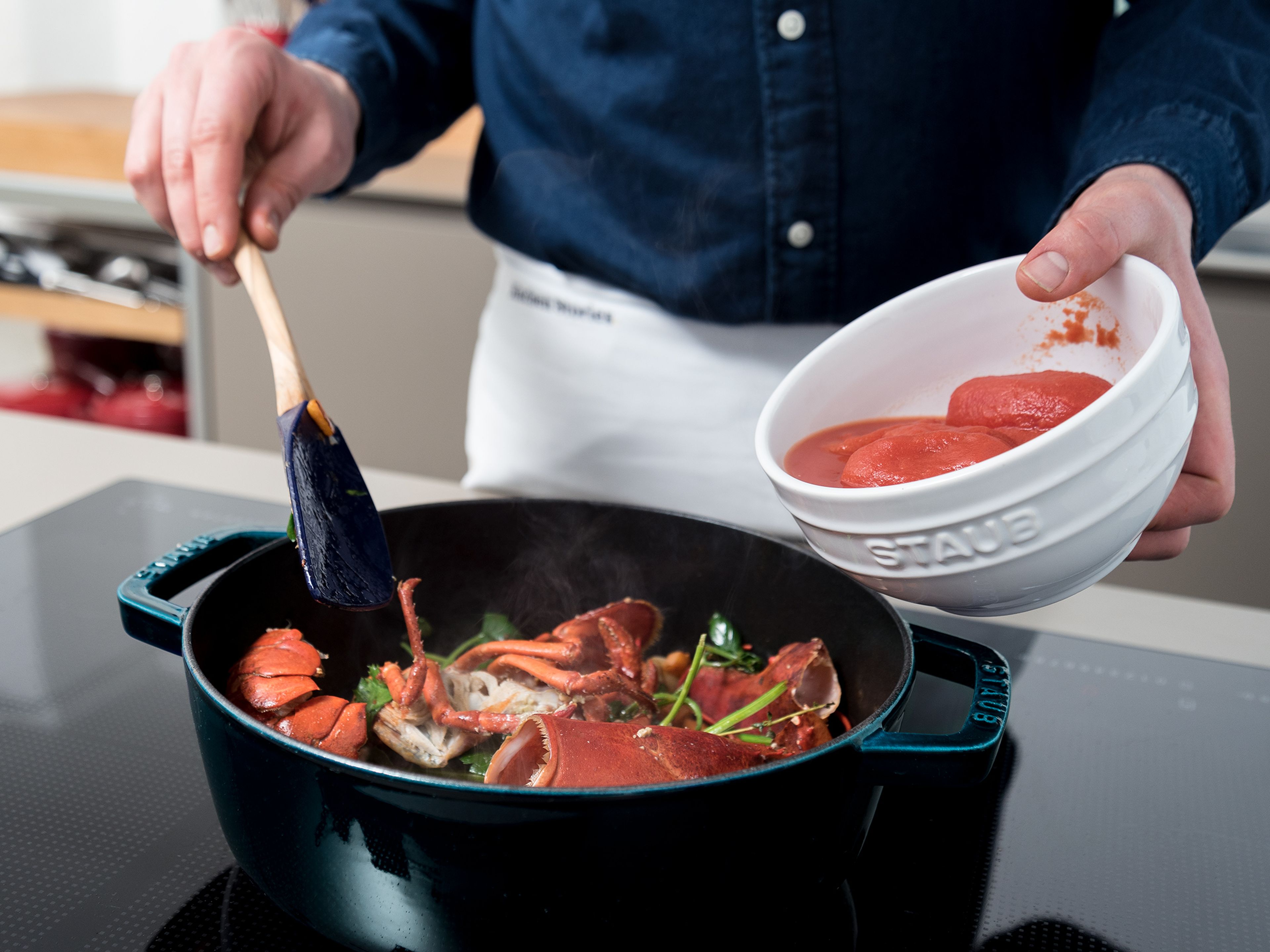 In a fresh pot or cocotte, heat half the olive oil over medium-high heat. Add the carrot, shallots, and garlic. Sauté for approx. 1 min. Stir in the lobster shells, thyme, bay leaf, parsley, and tomato paste. Add the tomatoes and wine and season with Piment d'Espelette, salt, and pepper. Cover and cook for approx. 20 min. over medium heat. Stir in the sour cream and reserved roe, should you have had a female lobster. Reserve and rinse lobster head and tail for plating. Salt to taste.
