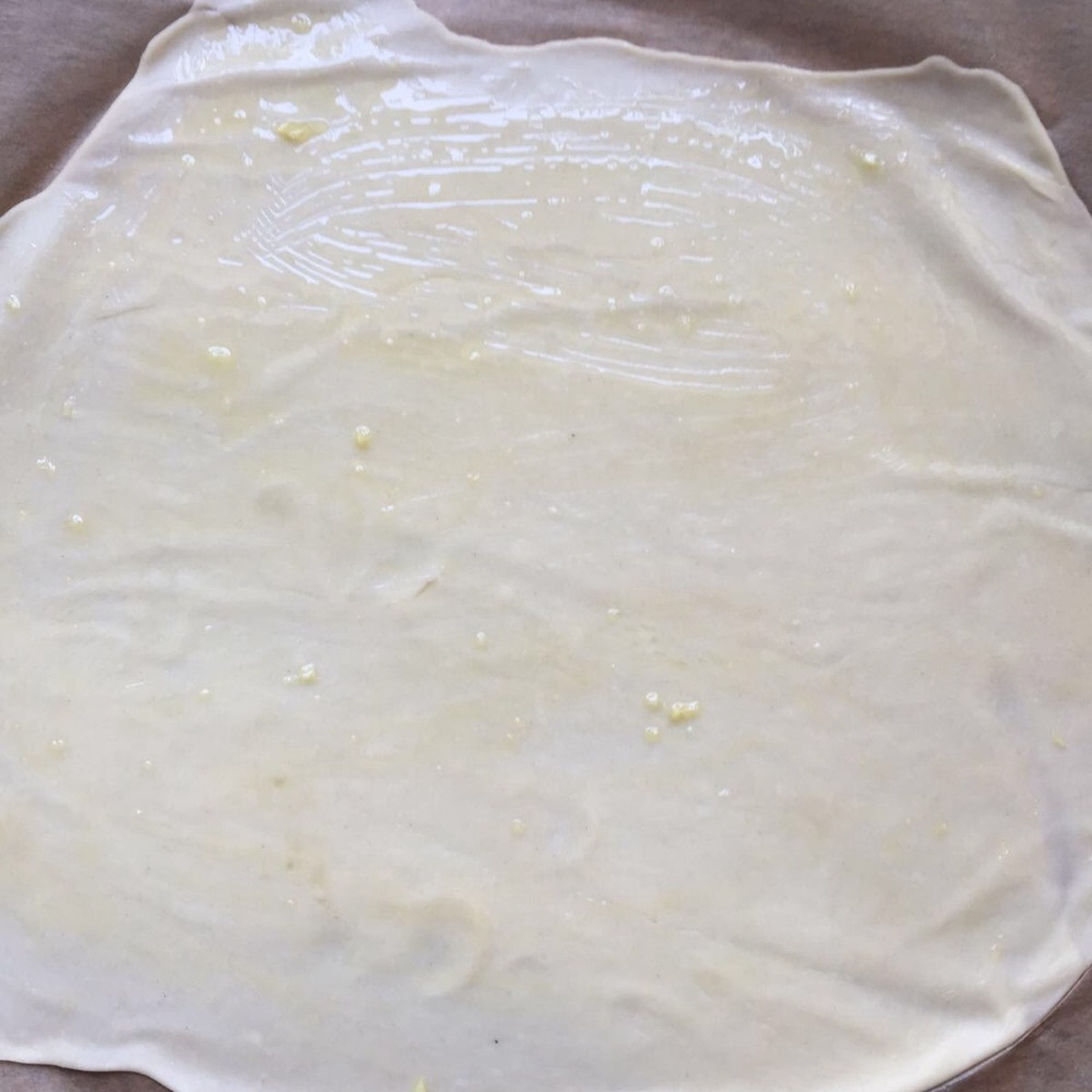 Brush the rested flatbreads with garlic oil.
