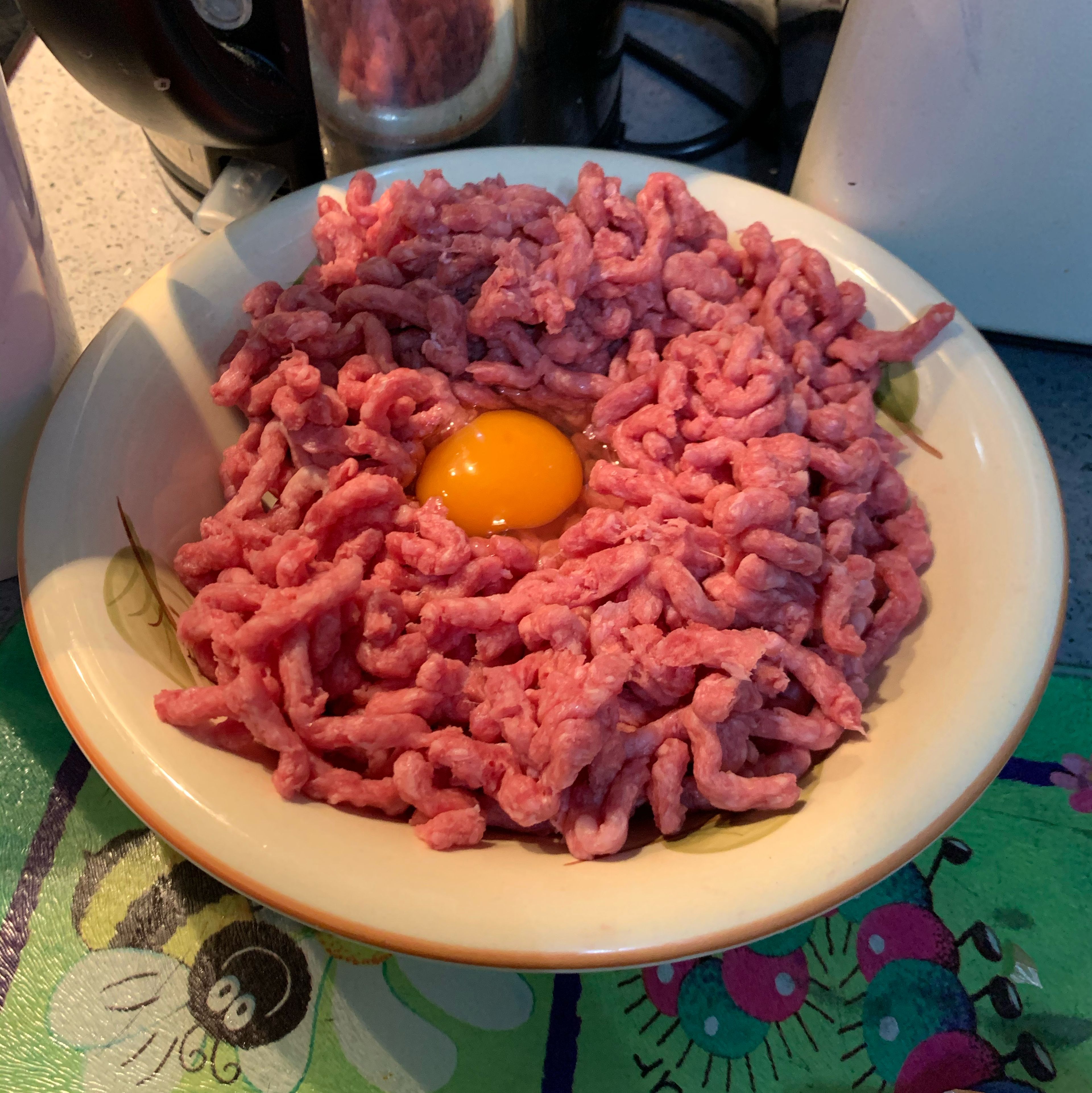 Prepare the steak mince by putting the 250g of mince in a bowl and add one whole egg.