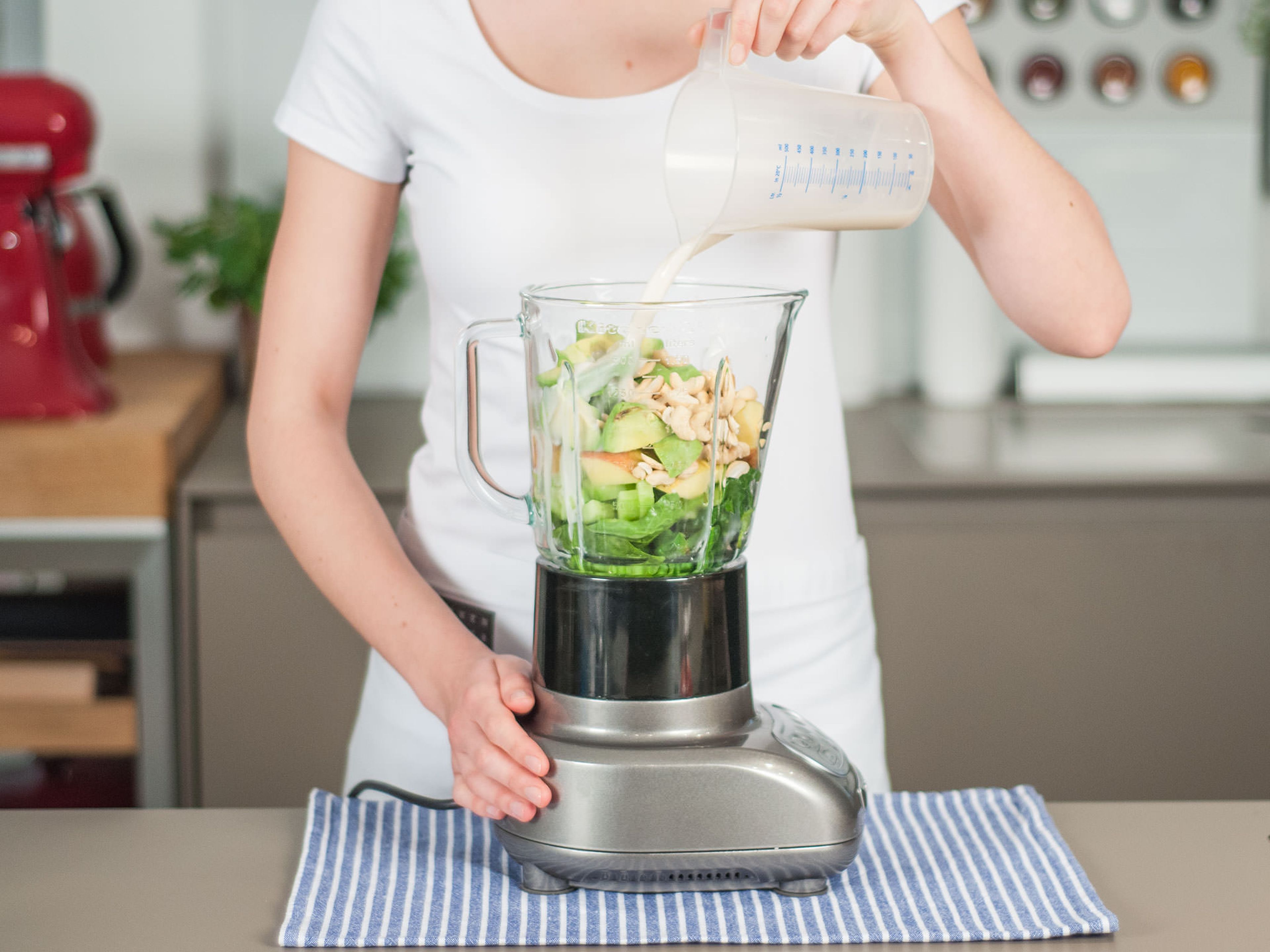Add chopped apple, cucumber, cashews and avocado to blender. Add spinach, water, lime juice, agave syrup. Pour in almond milk. Then, blend on high until smooth, approx. 2 – 3 min. Enjoy right away!
