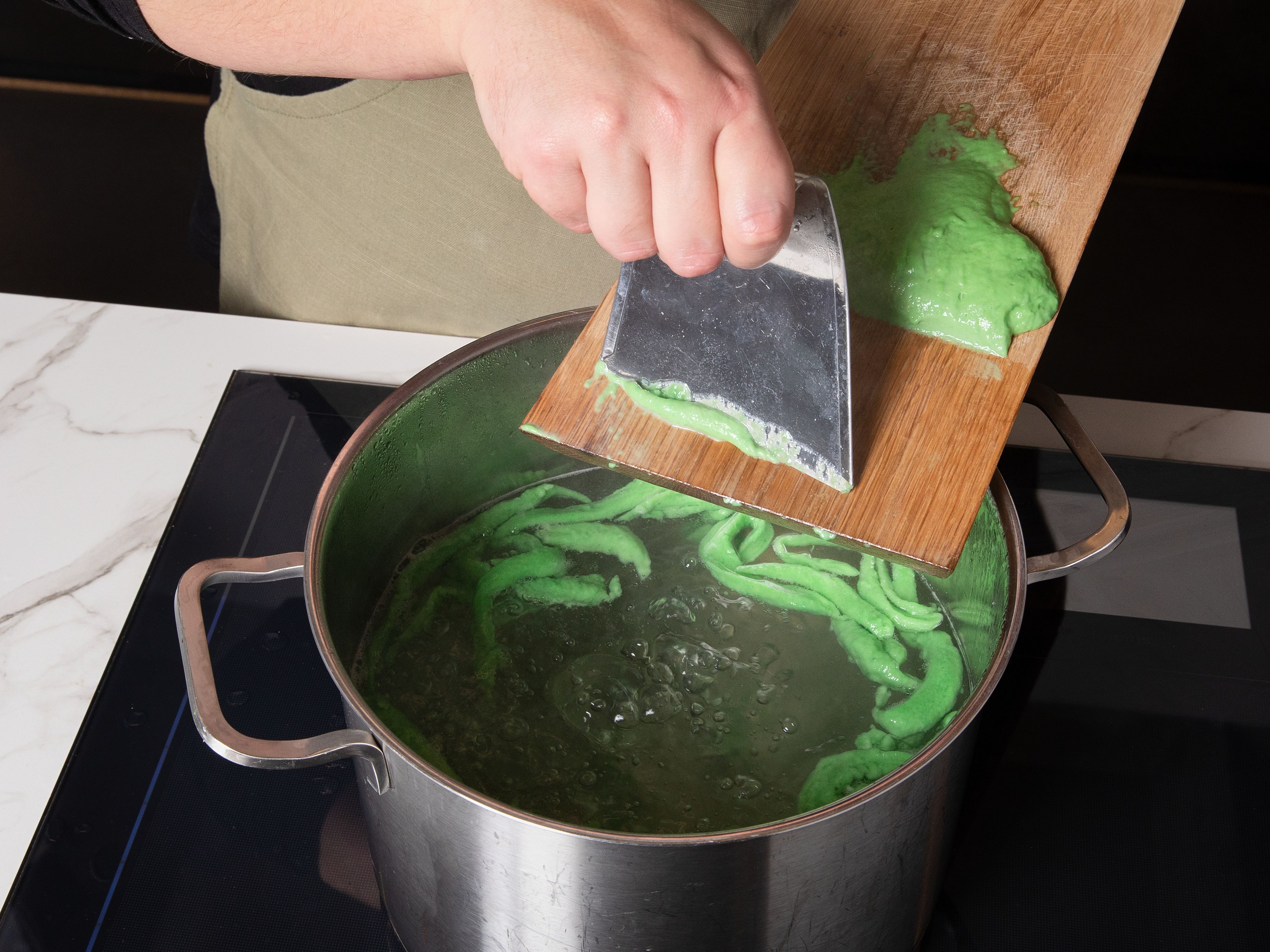 Bring a large pot of plenty of salted water to a boil. Use a Spätzle press or a Spätzle board to press or scrape dough directly into boiling water. Spätzle are done once they rise to surface. Remove them with a slotted spoon, let them drain well and make sure to reserve some of the cooking water.