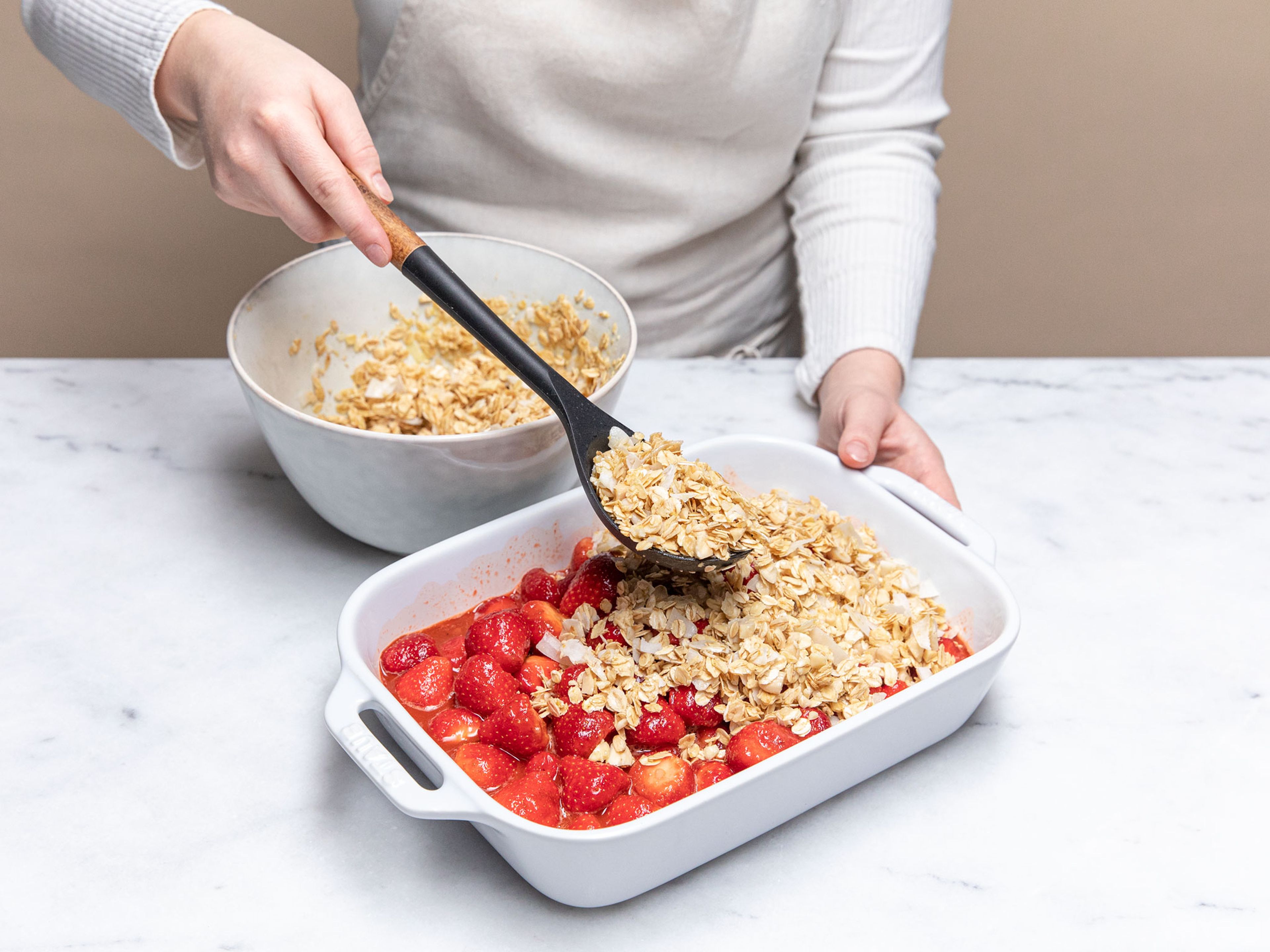Place strawberries in a baking dish. Spread granola mixture over strawberries and bake at 180°C/ 356°F for approx. 30-40 min, or until the granola is golden brown and the corners are bubbling.