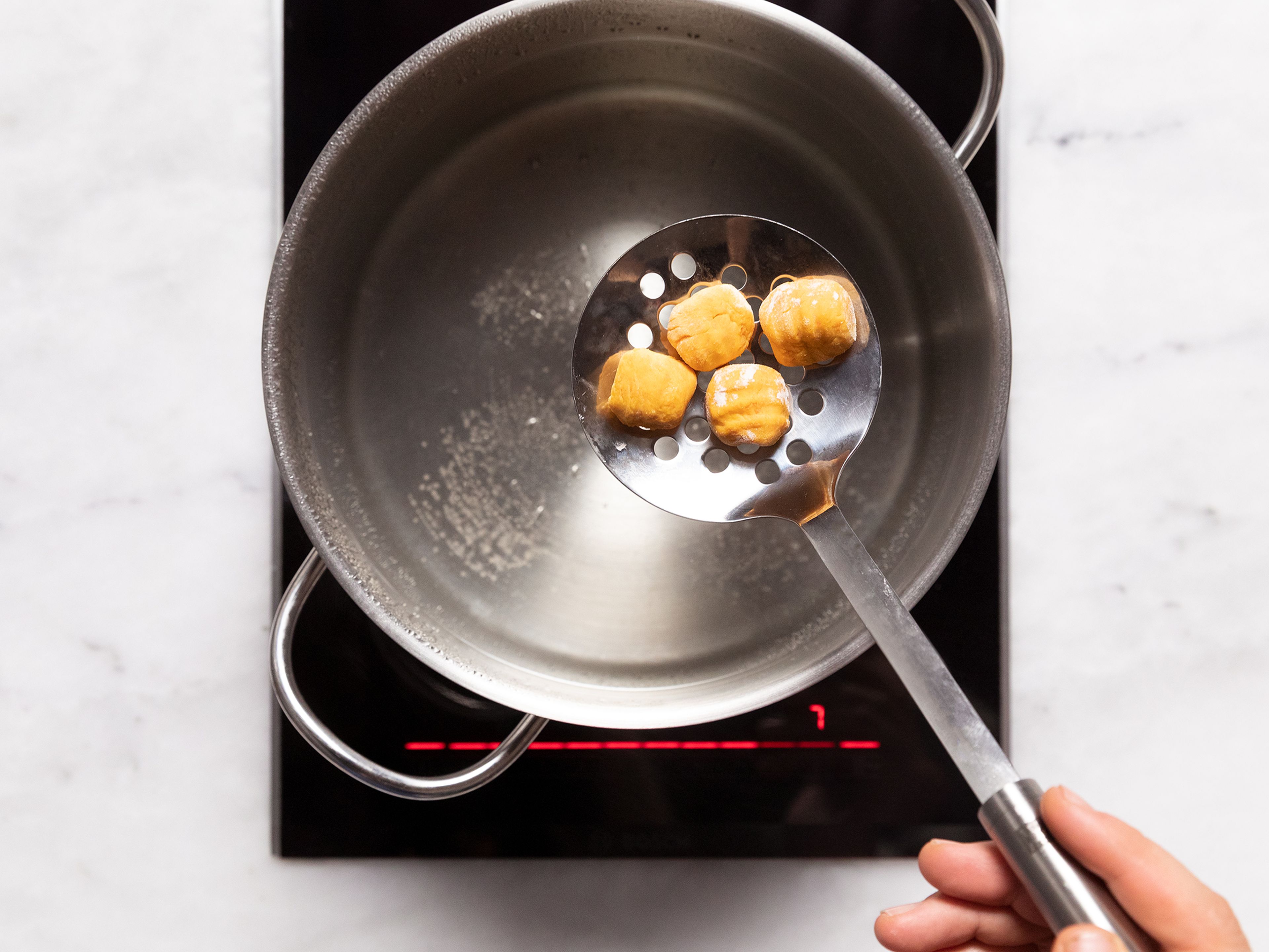 Bring a large pot with salted water to a boil. One after another, transfer gnocchi into the boiling water. Once they float, they’re ready, and can bet gently removed using a slotted spoon.