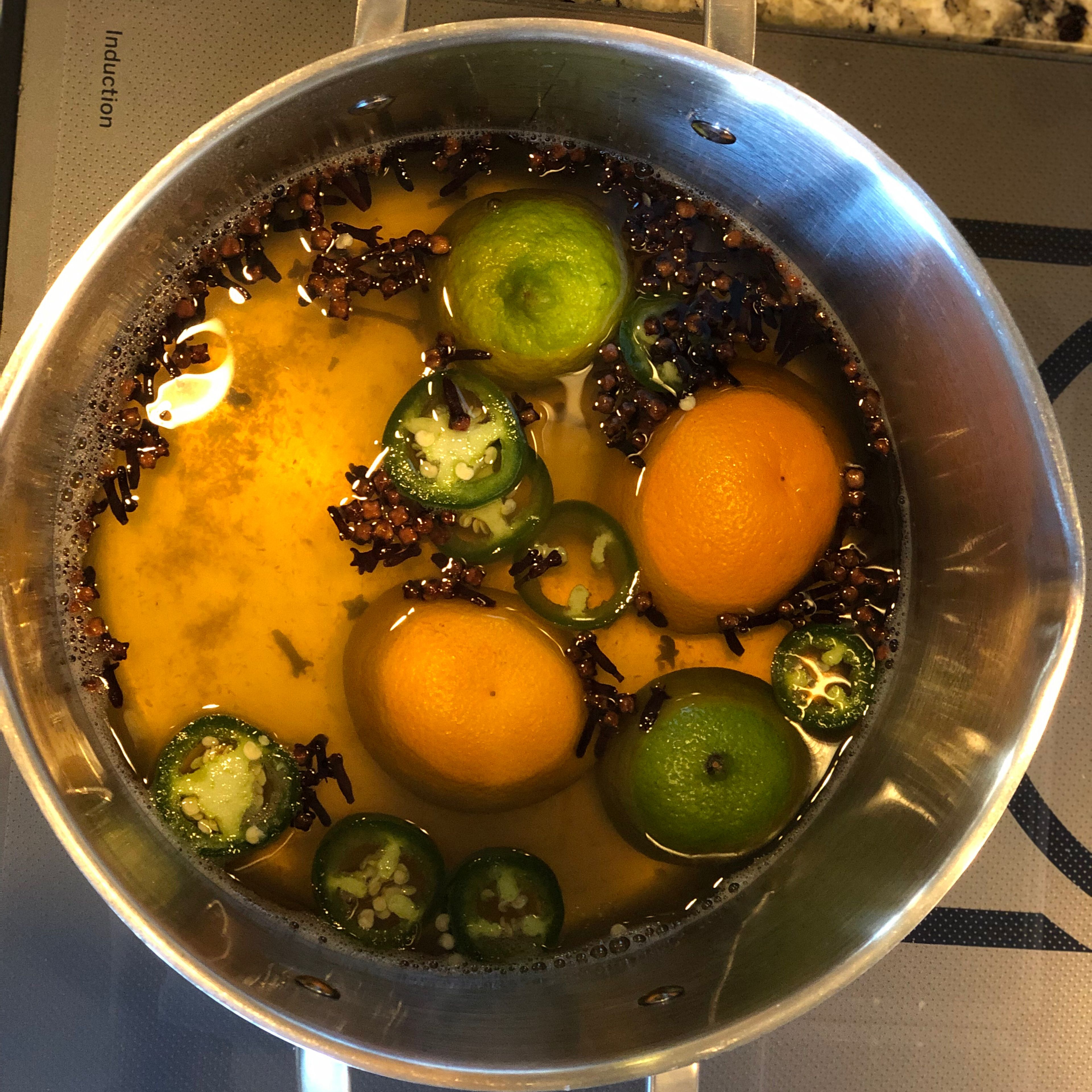 Add the jalapeños, cloves and star anise to the brining base.