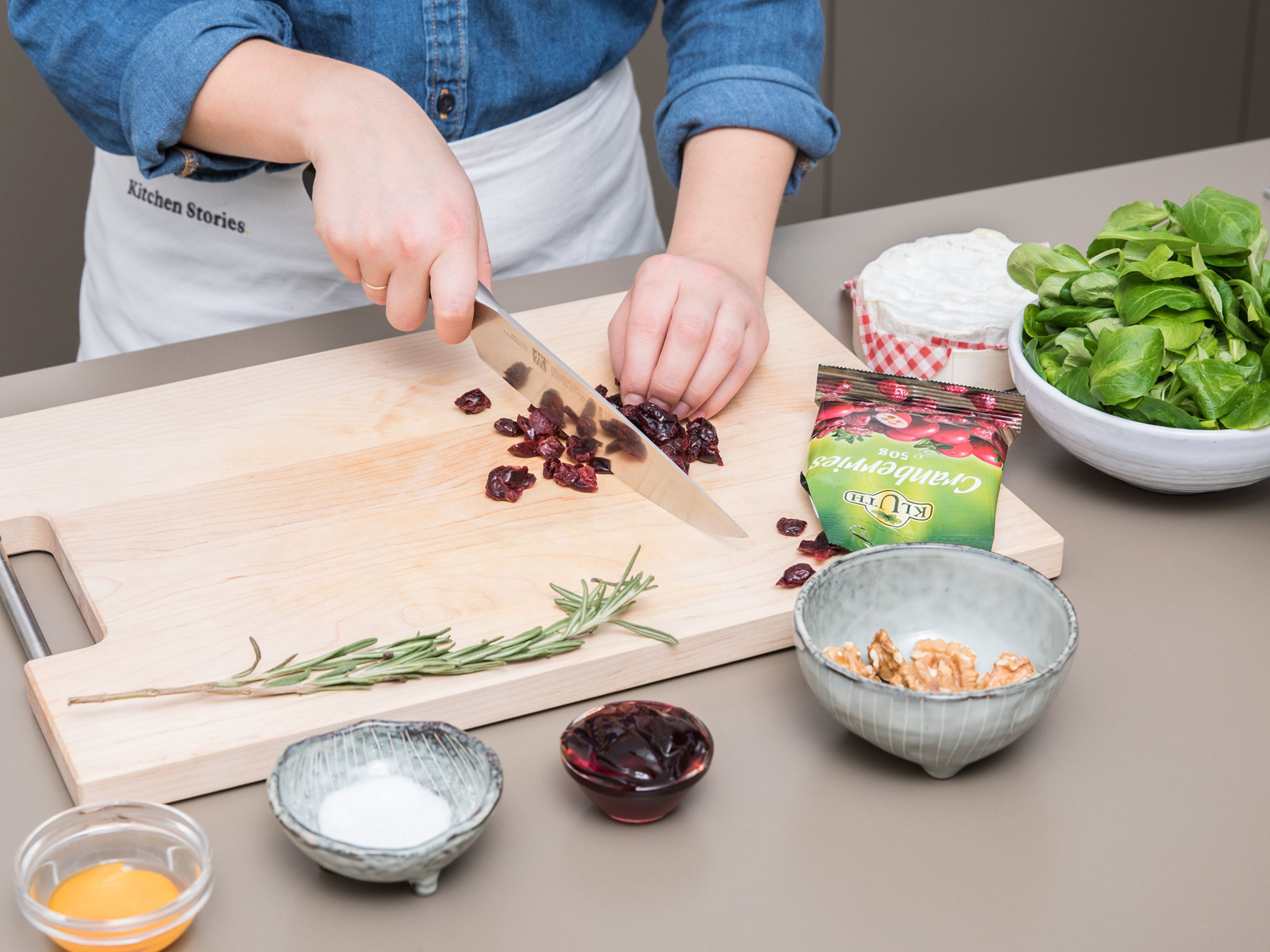 Preheat oven to 200°C/390°F. Roughly chop dried cranberries and walnuts, finely chop rosemary, and transfer to a bowl. Add cranberry sauce, salt, and pepper and mix well.