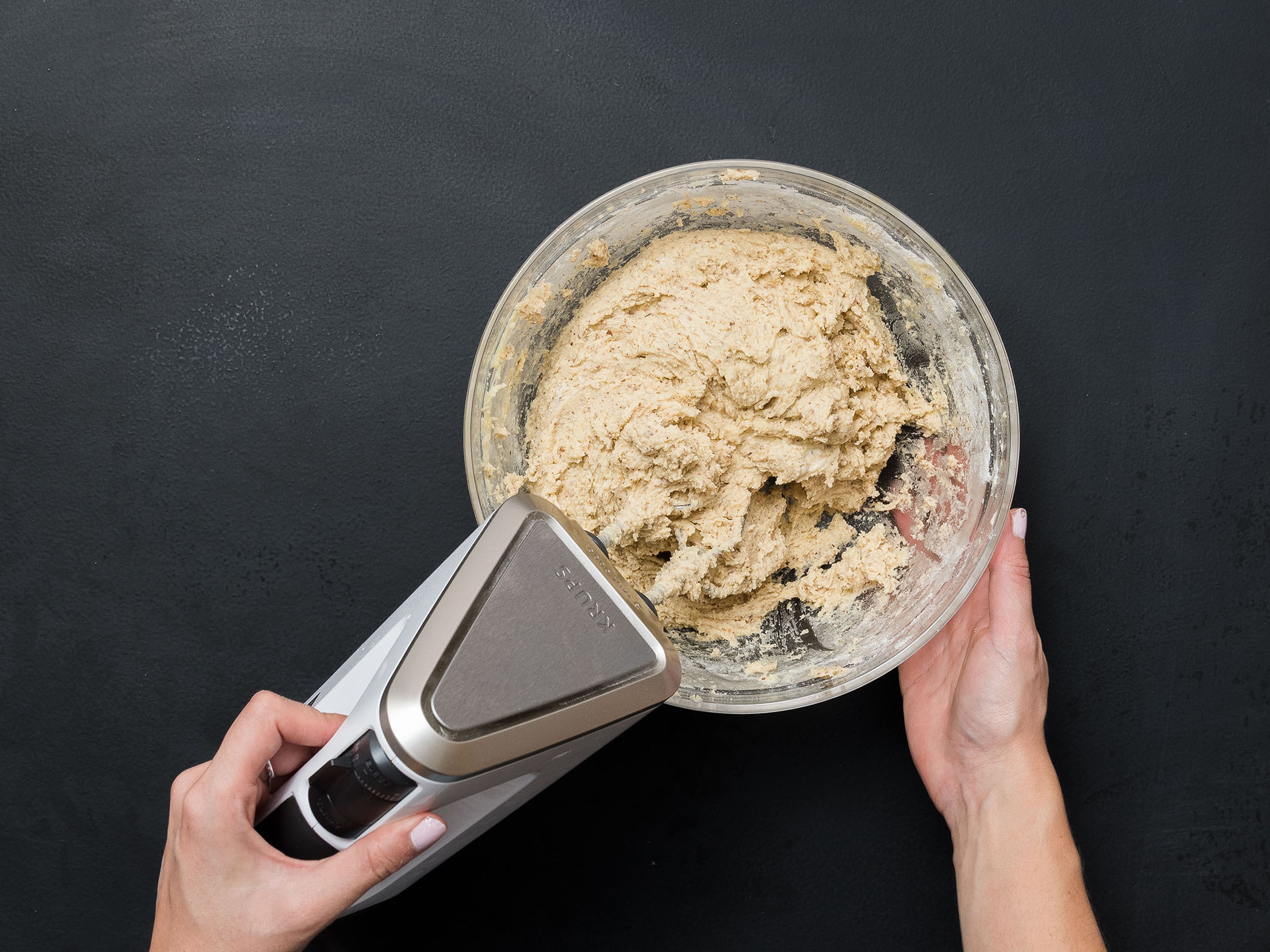 In a large bowl, mix flour and ground almonds and add to egg-butter mixture a little at a time, forming a fluffy dough. Add dough to a piping bag.
