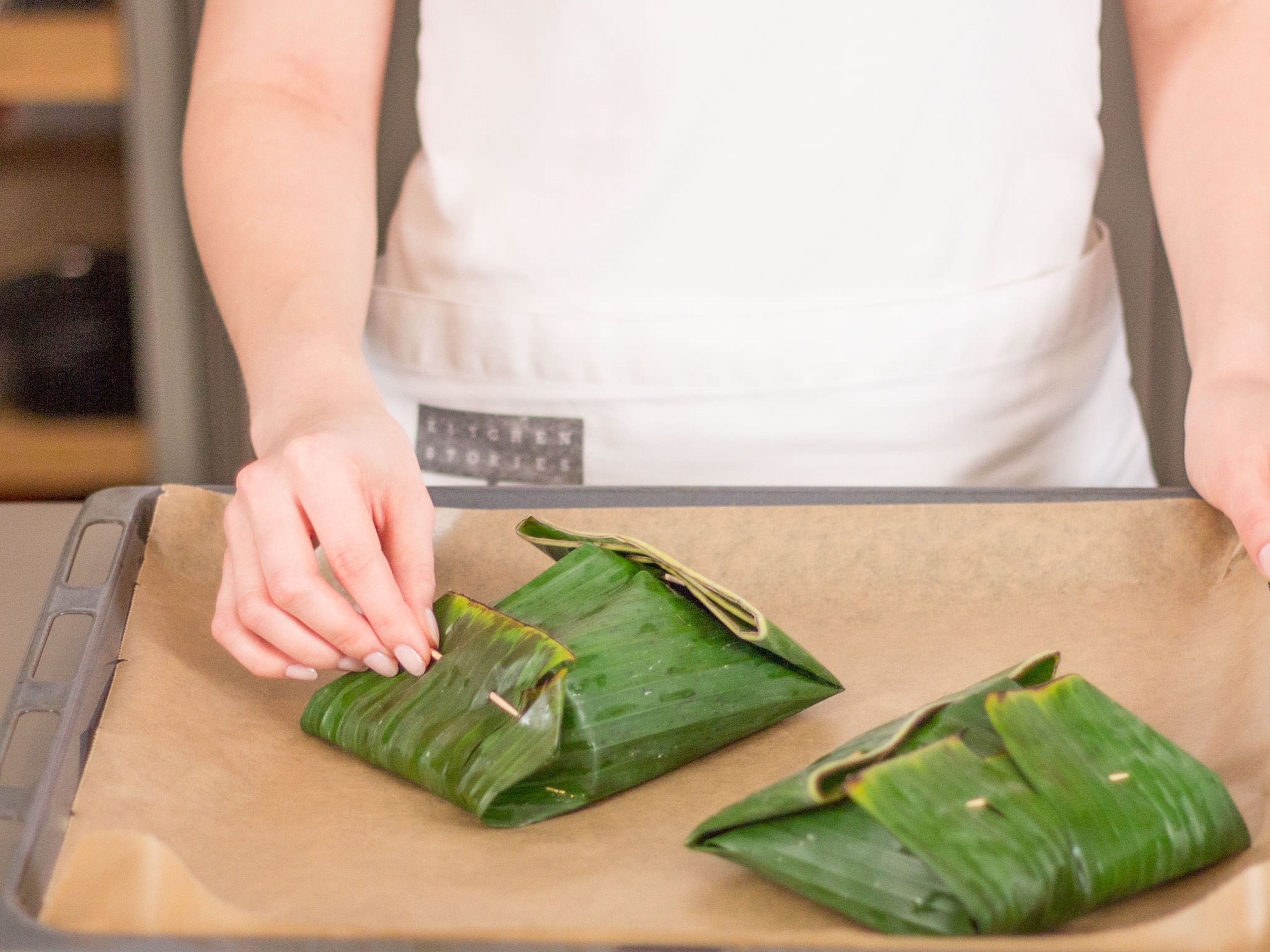 Fold banana leaves until all sides of cod fish are covered. Use toothpicks to secure the leaves. Bake in the oven at 180°C/350°F for approx. 30 min.