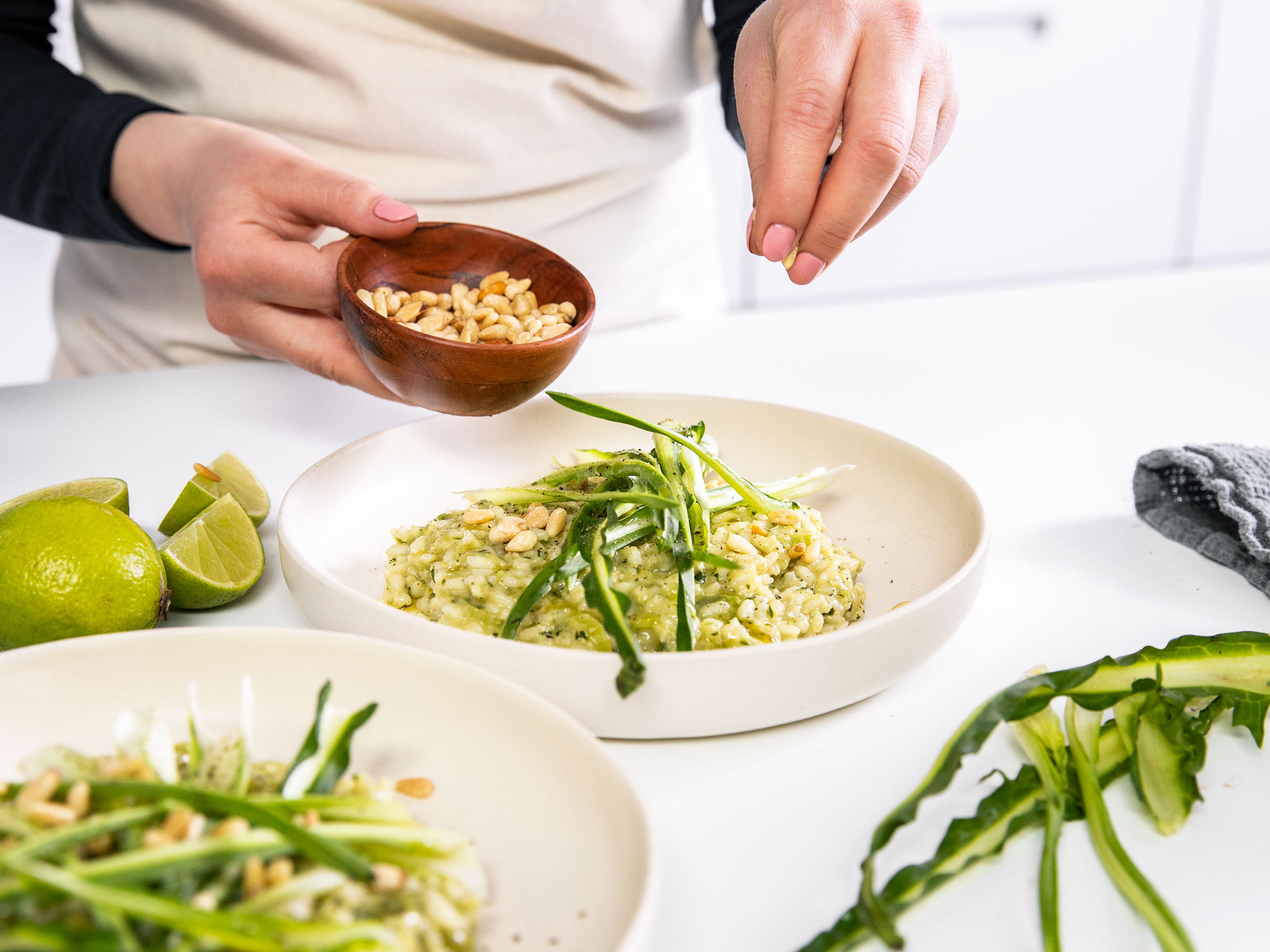 Once the rice is cooked, add butter, dandelion pesto, and lime zest to the pot and stir to combine. Season with salt and pepper to taste and serve green risotto with reserved dandelion leaves and toasted pine nuts. Enjoy!