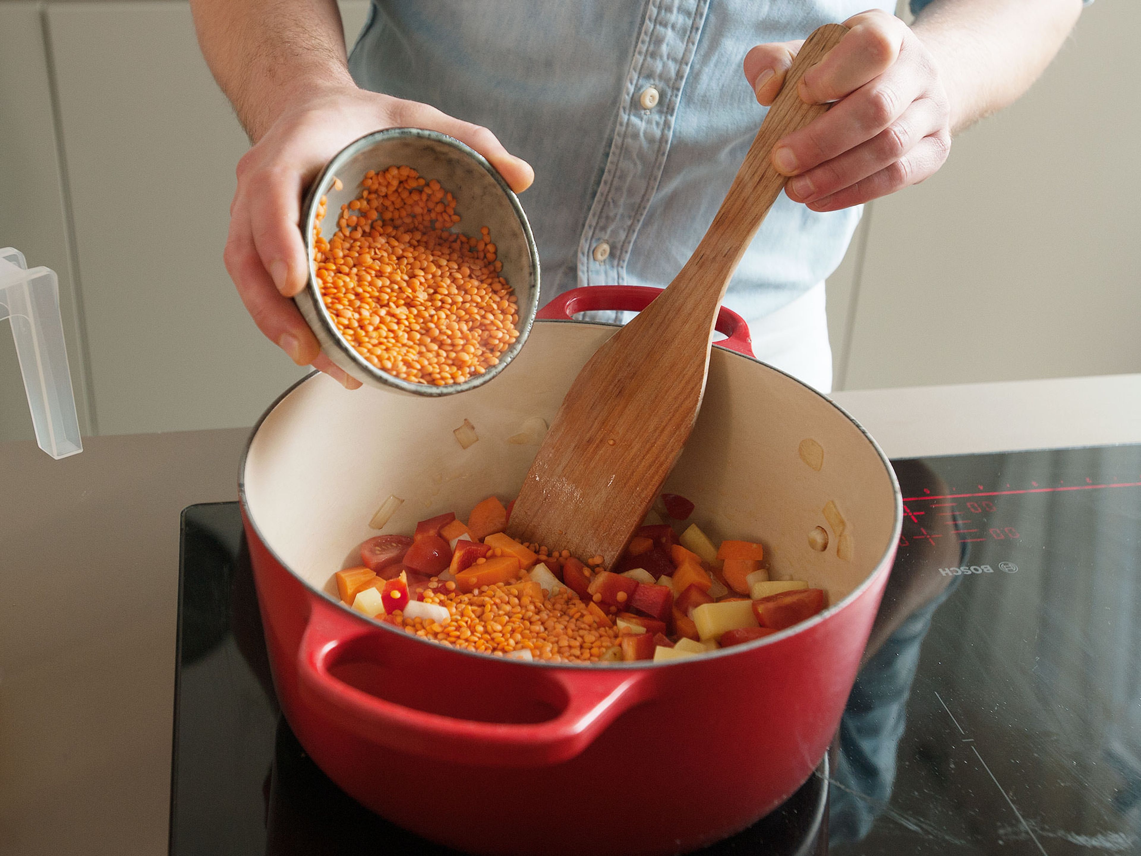 Melt some of the butter in a medium-sized pot over medium-high heat. Add onions and sauté until translucent. Add garlic, chili, tomatoes, bell pepper, carrot, potato, some of the ground paprika or our AROMEN REICHTUM seasoning (if using), and lentils. Cook for approx. 3 – 5 more min.
