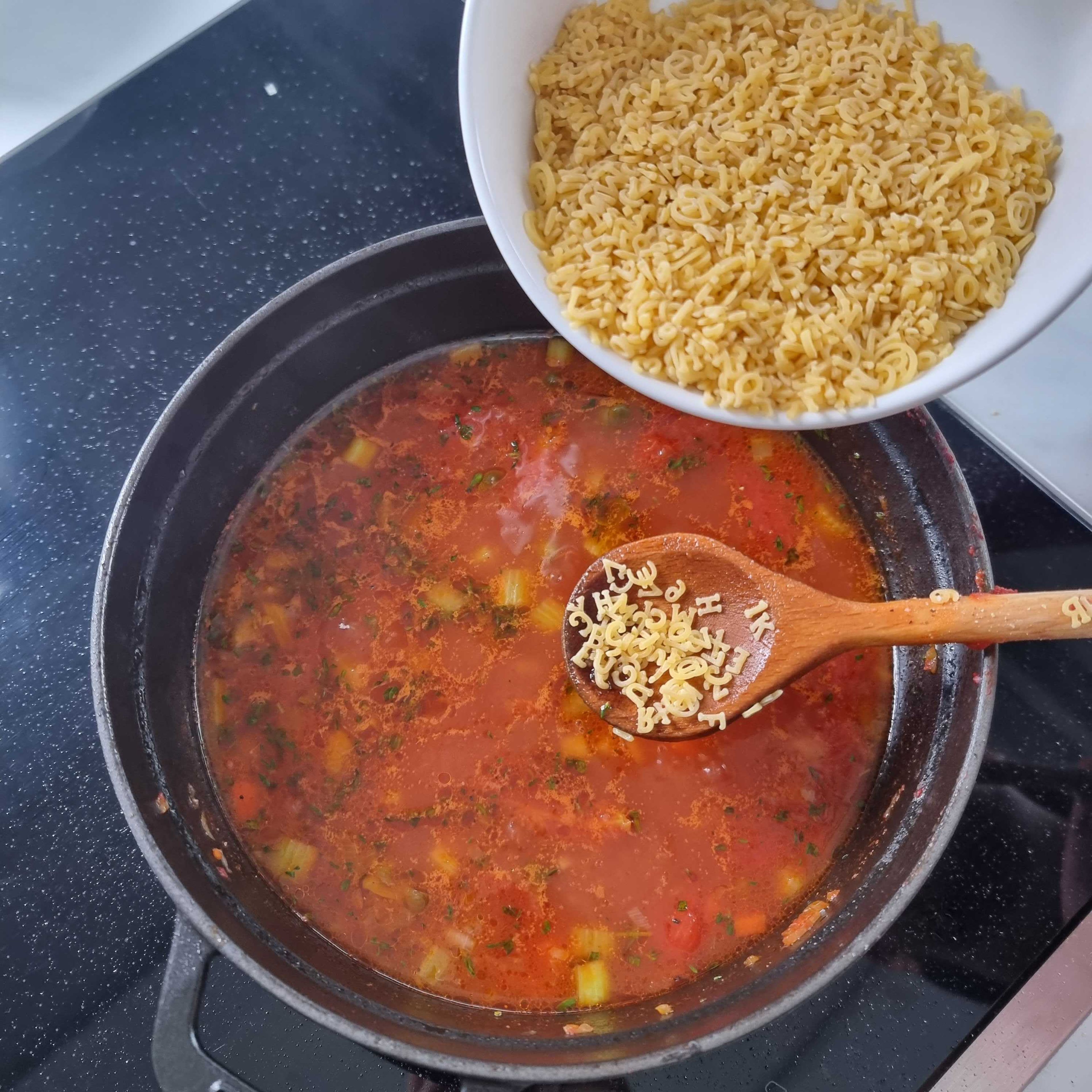 Als Nächstes die Buchstabennudeln hinzufügen und ca. 7-8 Min. kochen lassen oder bis sie "al dente" gekocht sind. Zuletzt die Kräuter in die Suppe einrühren. Die Suppe mit gehobelten Parmesan servieren. Guten Appetit!