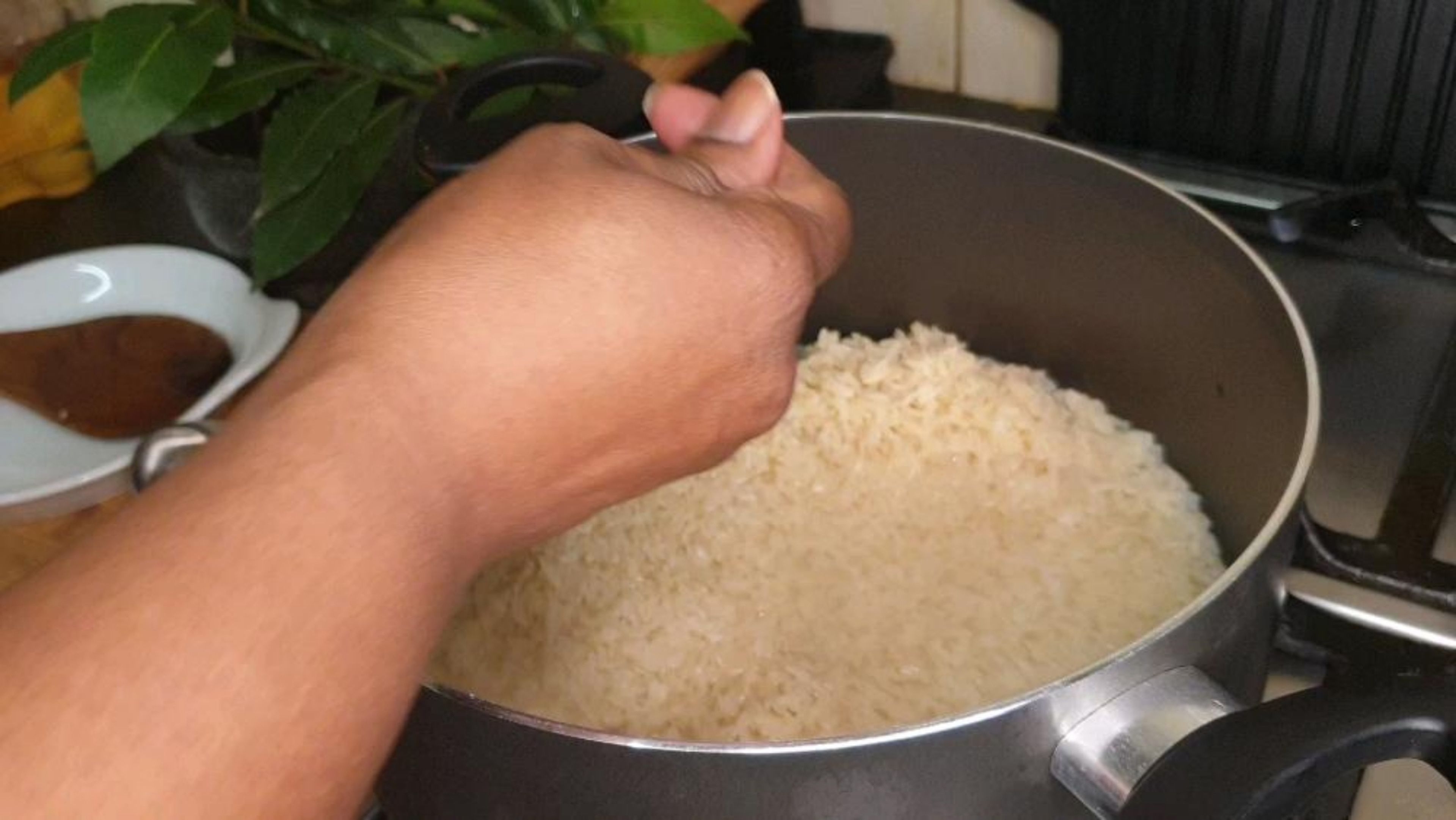 Transfer washed rice to pot. Add 1 ½ cups of cold water. Add 1 maggi cube, 1 bay leaf, 1 teaspoon of oil & 1 teaspoon of maggi sauce. Mix well, stir, cover and cook on medium heat for 8 minutes. This process starts to build a good taste profile for your Jollof rice