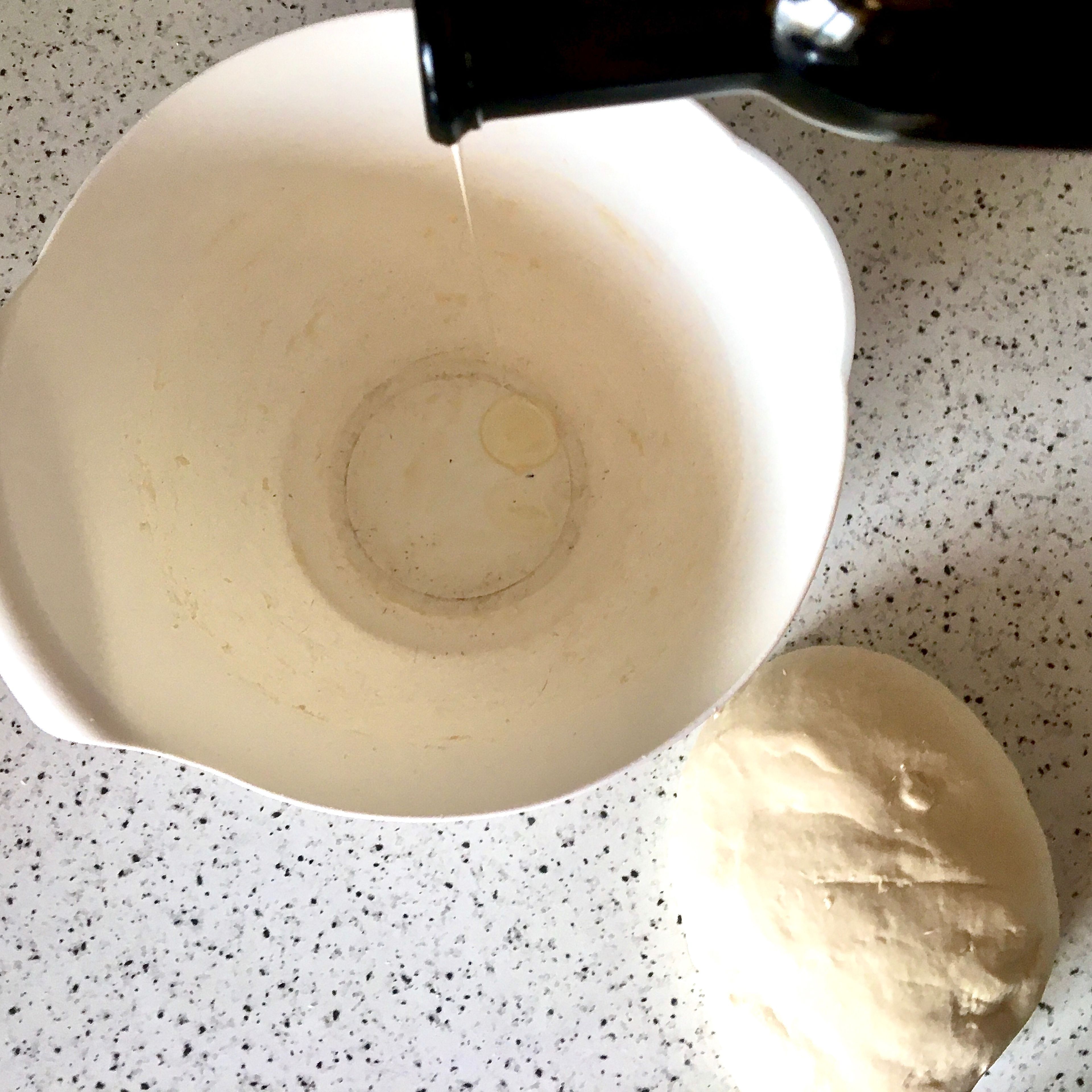 Drop a little oil in the bowl and swirl around to coat the bottom. Shape the dough into a ball and place in the oiled bowl. Cover with a damp kitchen towel and let rise until doubled in size, about 4 hours.