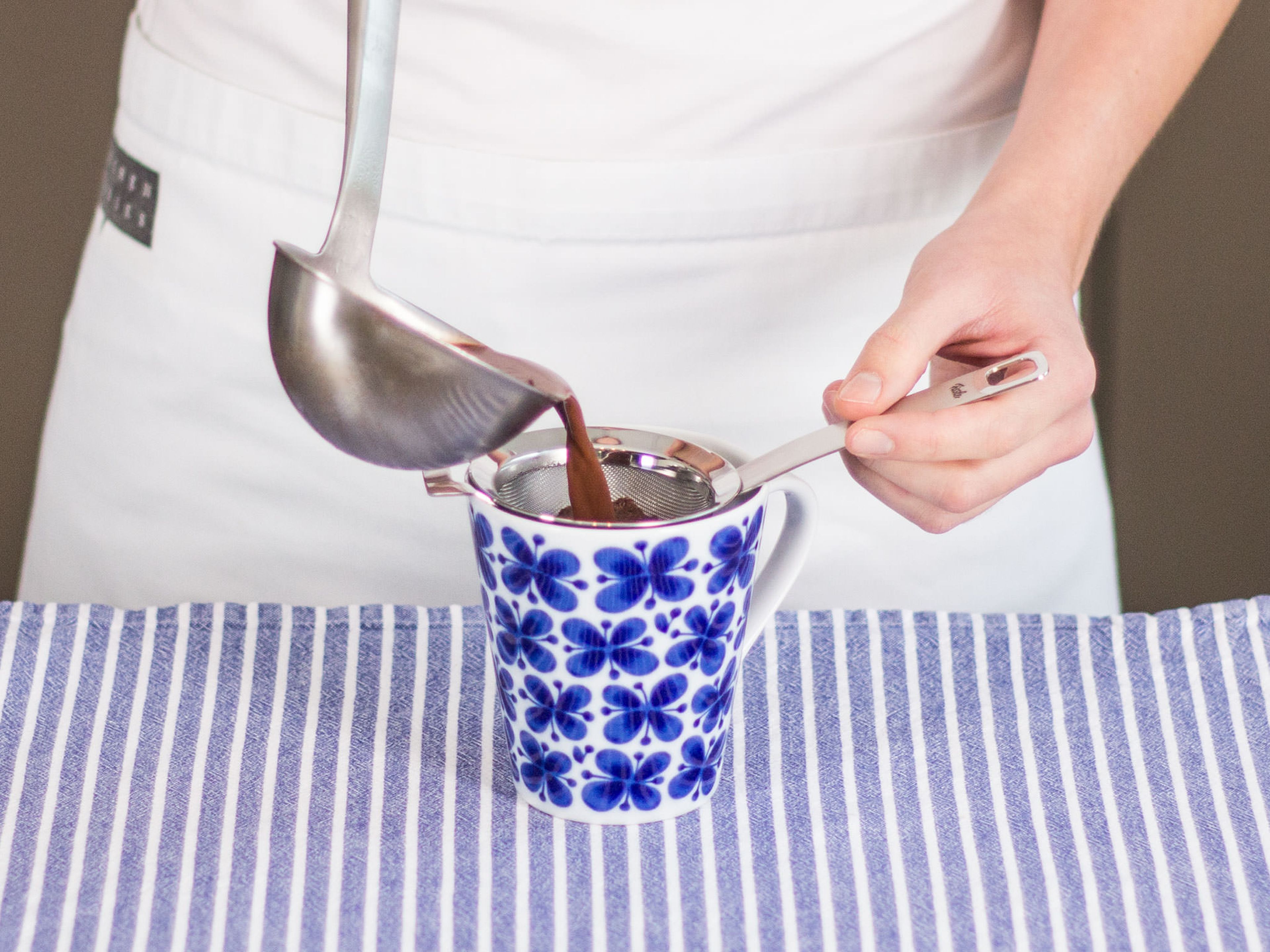 Place a sieve over a cup for serving. Ladle chai hot chocolate into mug. Remove sieve and enjoy straightaway!