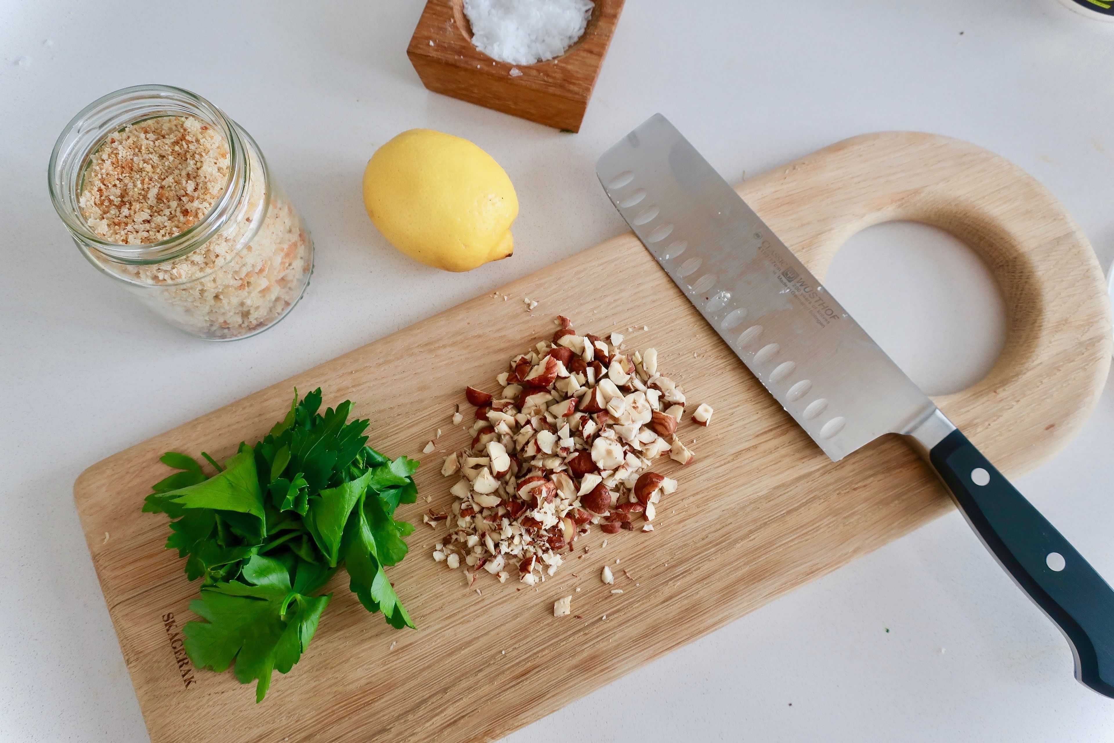 Meanwhile, to make the gremolata, roughly chop the hazelnuts, finely chop parsley and zest half a lemon. Add a little oil to a frying pan over medium heat. Add breadcrumbs and hazelnuts and fry until toasted. Remove from heat, let cool slightly and mix with the parsley, lemon zest, and a pinch of salt.