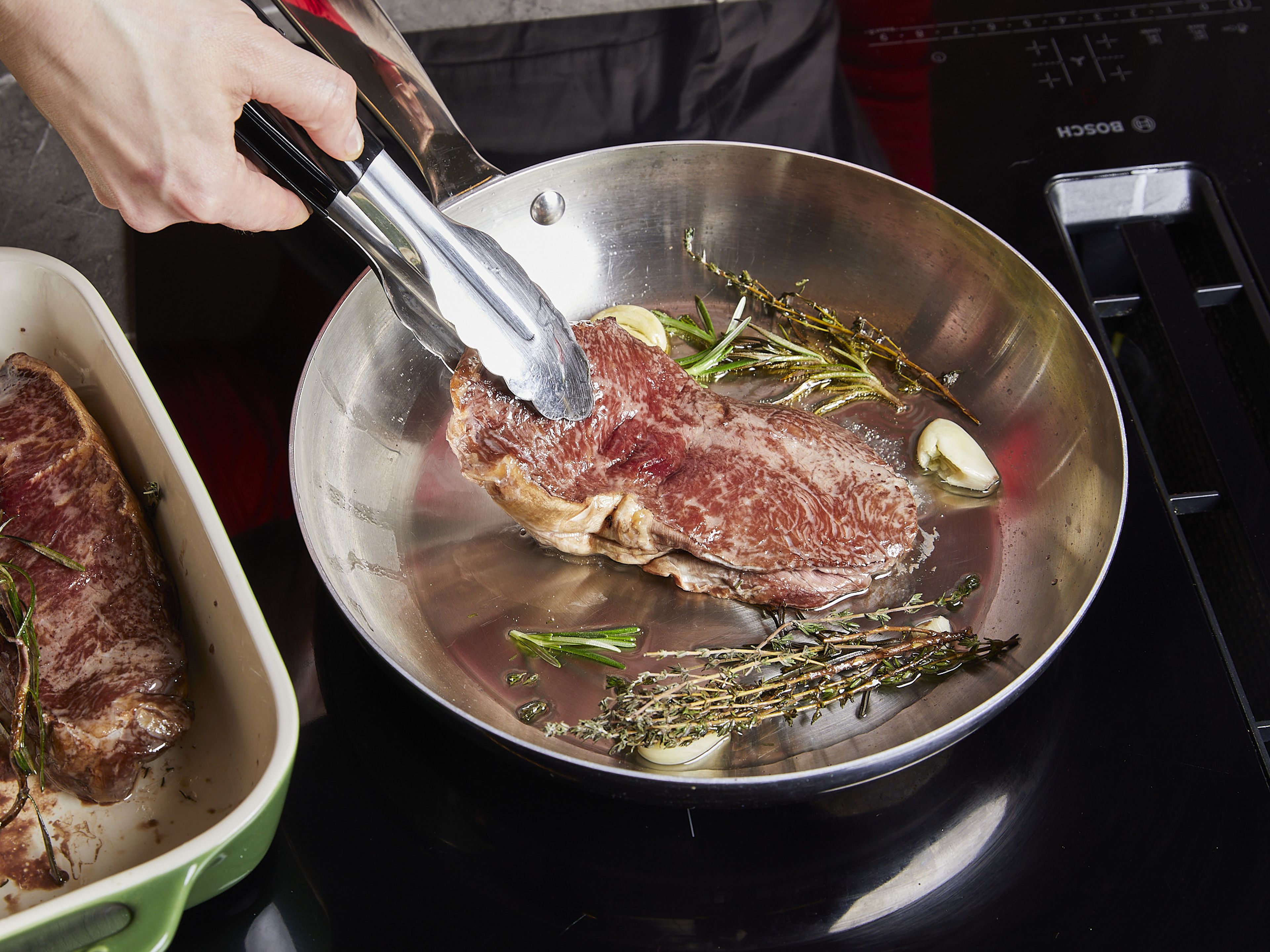 Heat a steel or cast-iron pan over high heat (we do not recommend using a non-stick or Teflon pan). Place the steaks, herbs, and garlic in the pan straight from the oven. Sear for approx. 2 min. on each side, remove and leave to rest for 10–15 min. Enjoy!