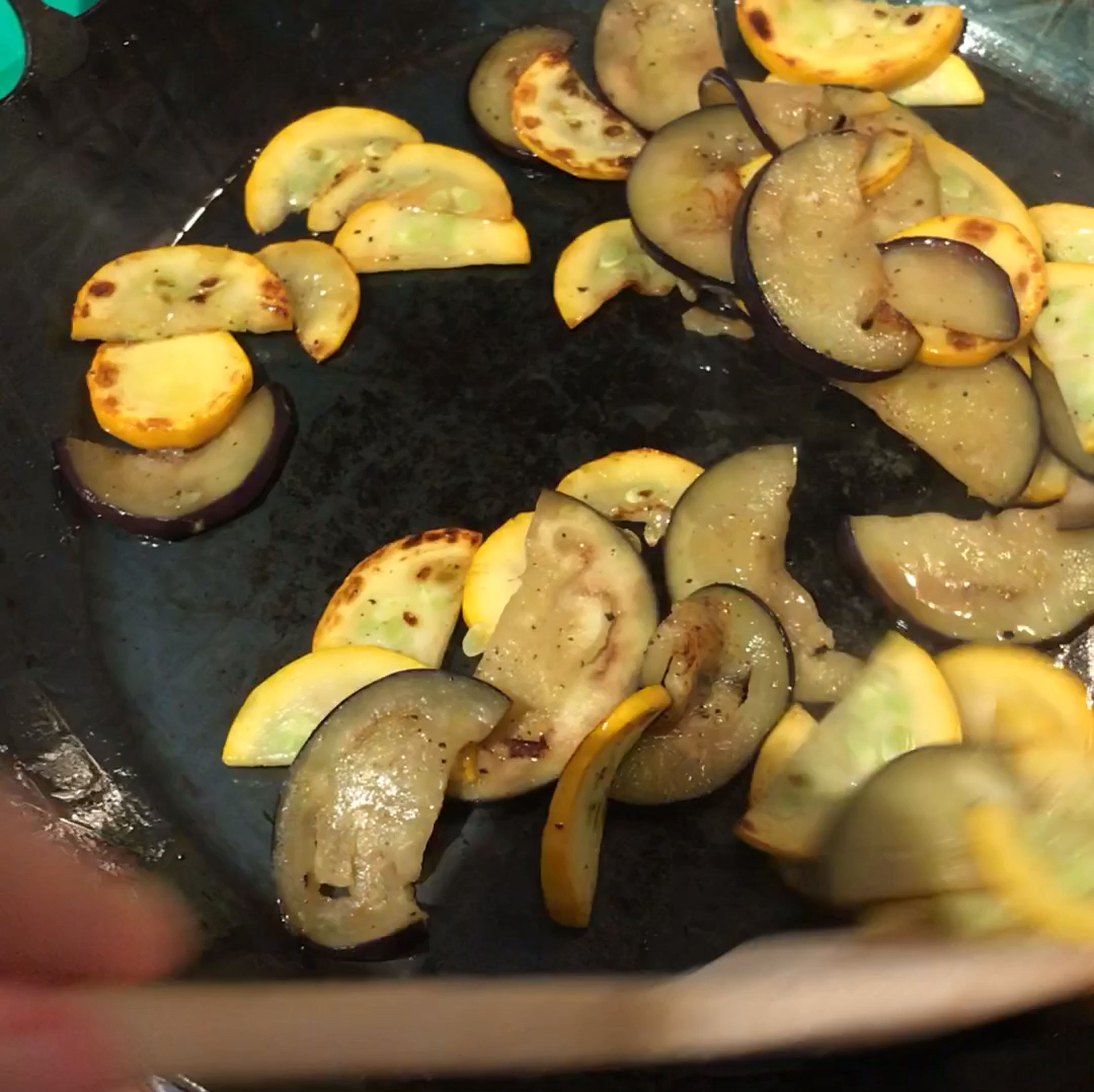 Slice eggplant and zucchini into bite-sized pieces. Heat pan over medium-high heat and coat generously with olive oil. When oil is hot, add eggplant and zucchini and fry, stirring often, until well browned. Season with salt and pepper to taste. Set aside until cooled slightly, then add to salad.