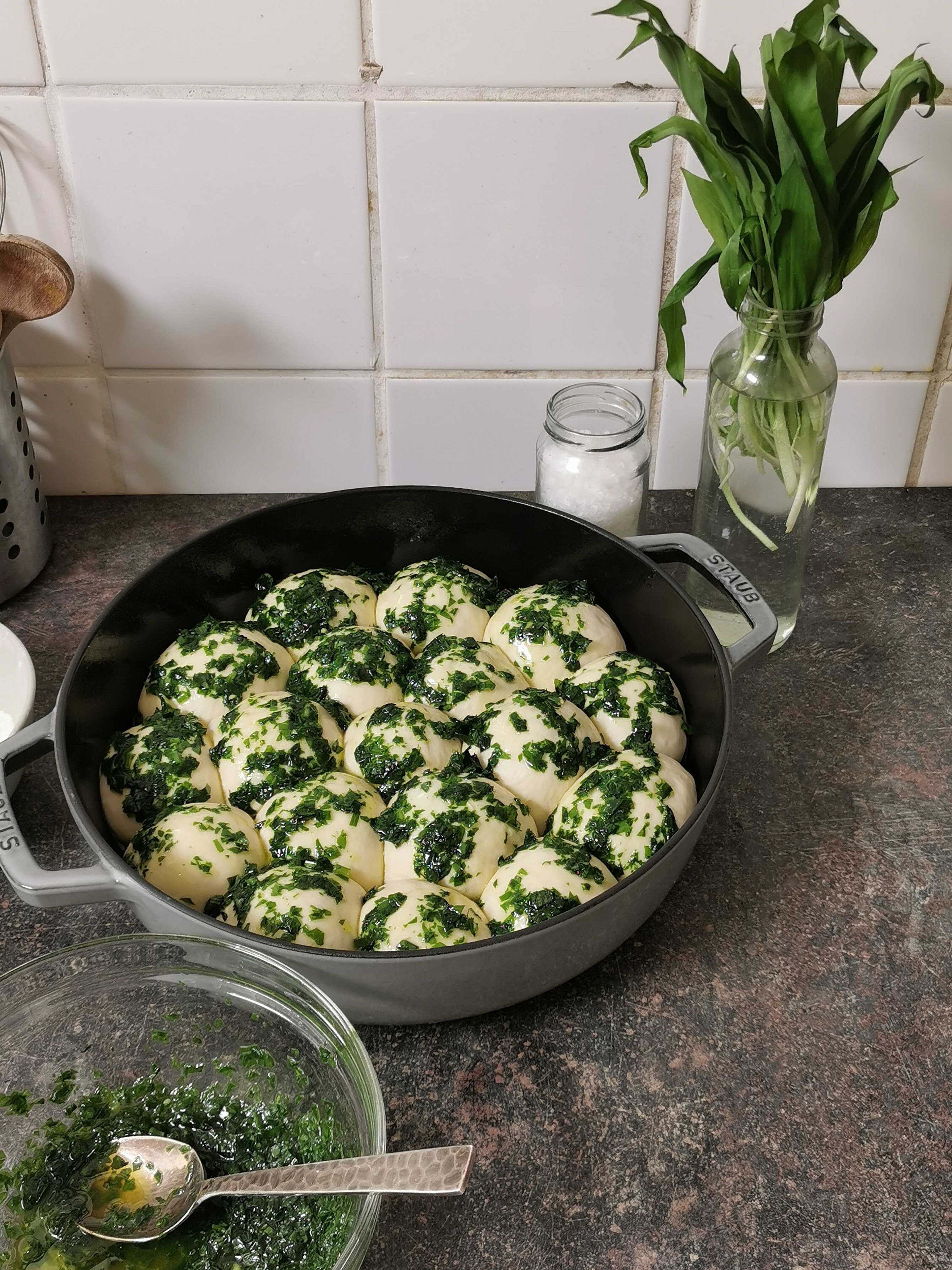 Preheat the oven to 200°C/390°F. Brush the balls generously with about 2/3 of the wild garlic oil. Transfer pan to the oven and bake for approx. 20 - 25 min., or until golden brown. Remove from the oven, brush with the remaining wild garlic oil, and serve. Enjoy!