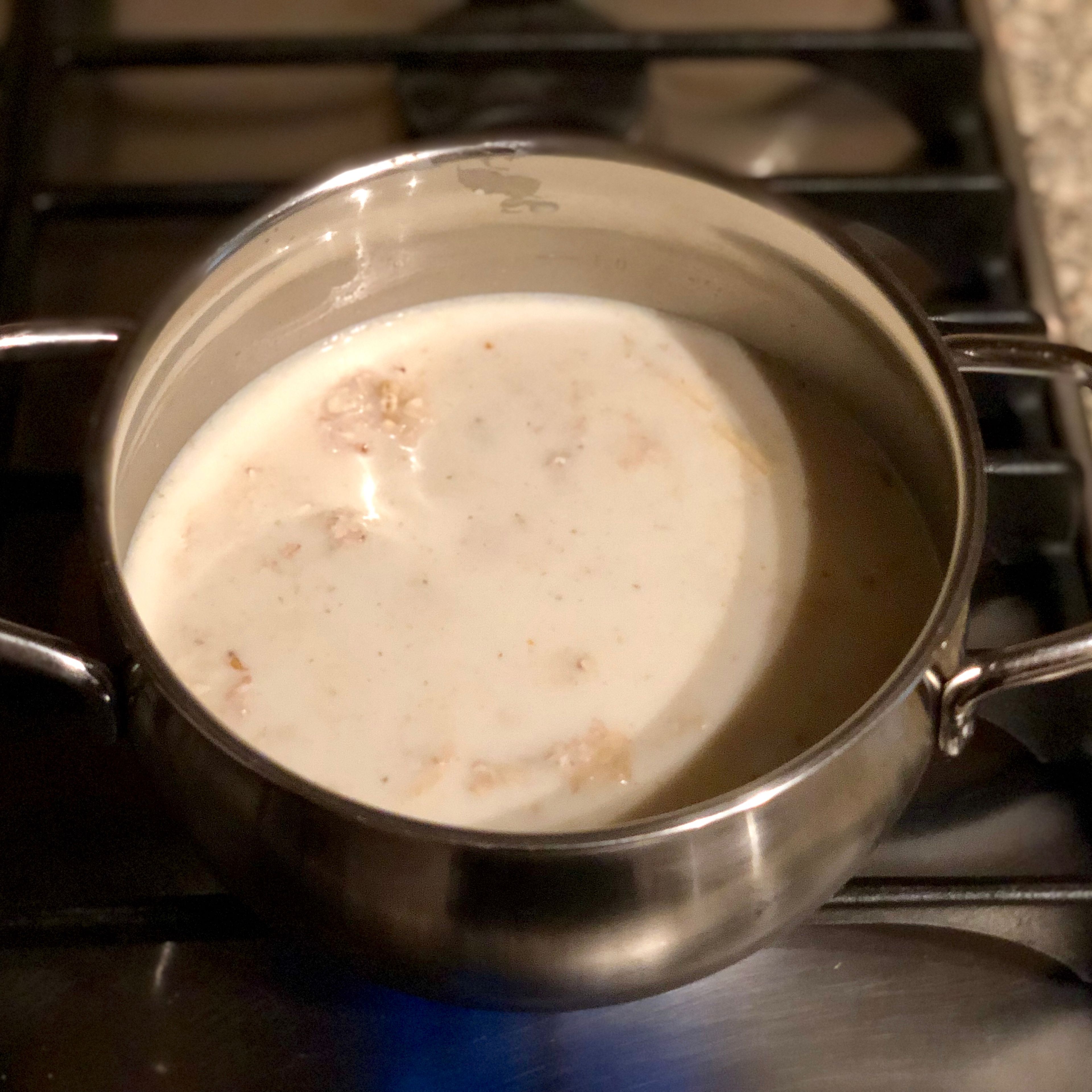 Combine oats, almond milk, already mashed banana, salt and vanilla extract in a small pot and cook on a medium/high heat, stirring occasionally. 5-7 minutes. Garnish with your favorite berries/nuts and enjoy.