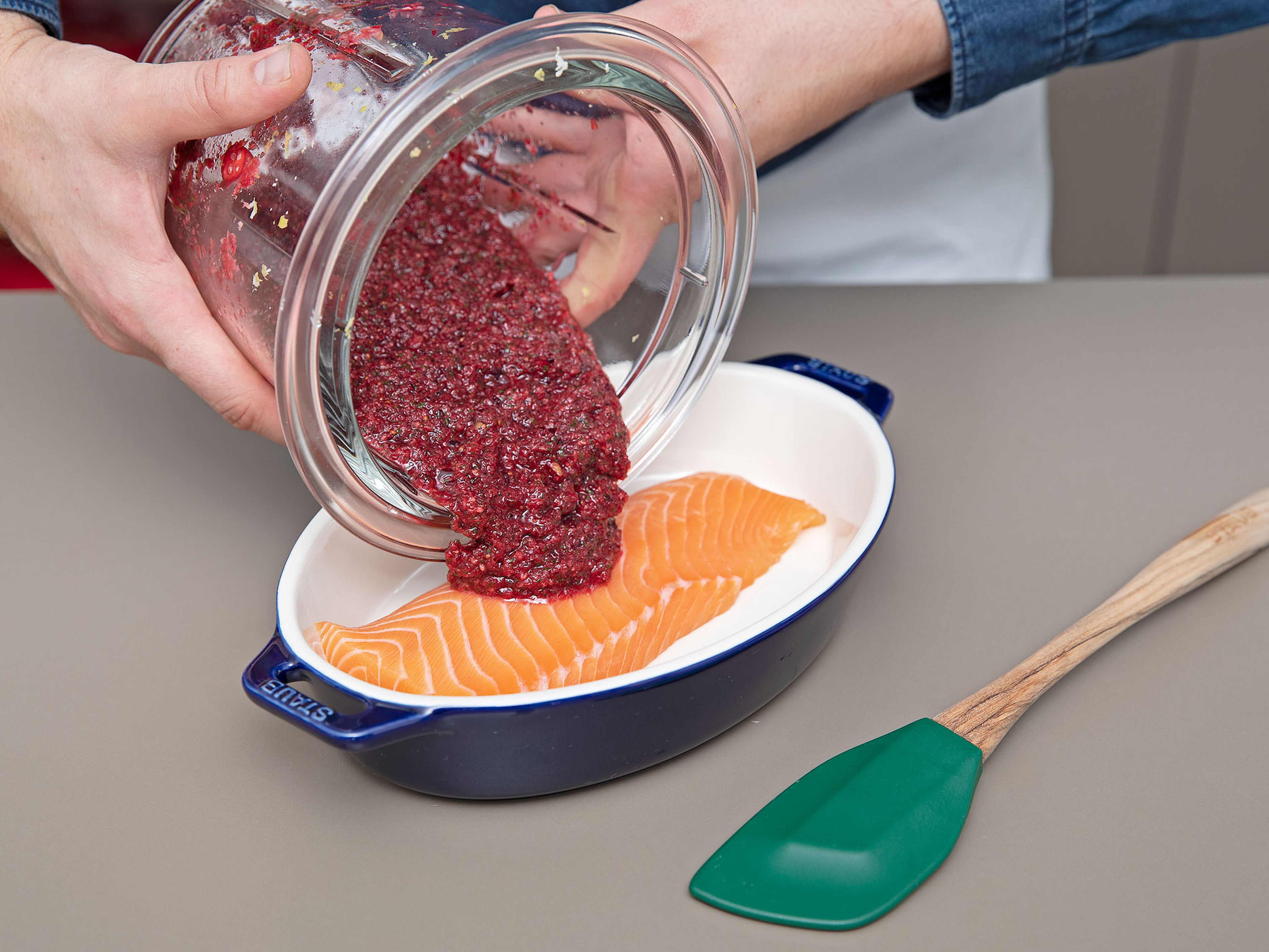 Add half of the cranberry paste to the bottom of a ceramic dish. Place the salmon on top and cover the top and the sides of the salmon with the rest of the paste until the paste is used up and the salmon is completey concealed.