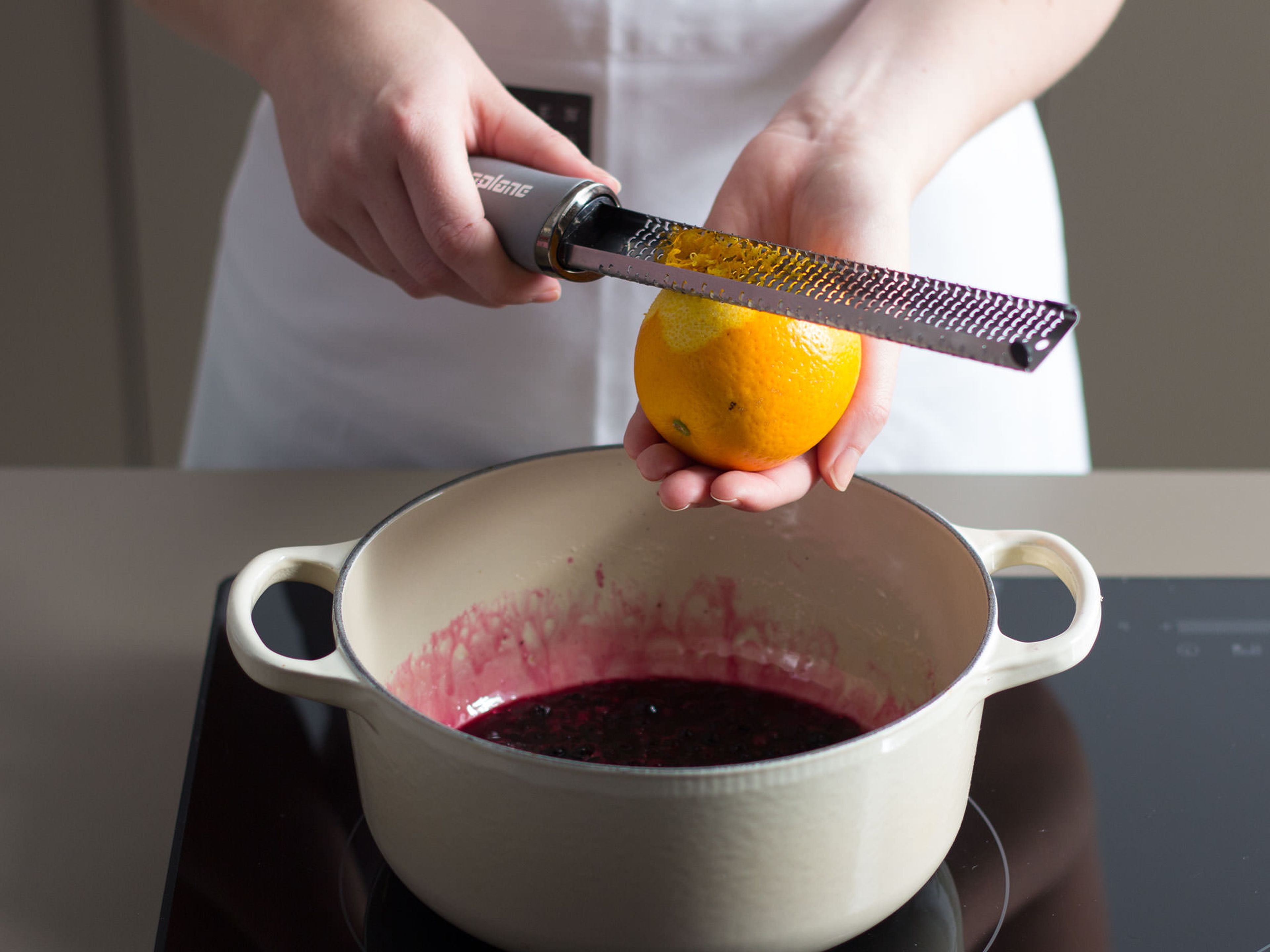 For the blueberry sauce, caramelize remainder of sugar in a large saucepan over medium-low heat for approx. 3 – 5 min., stirring constantly. Deglaze with lemon and orange juice. Then, add frozen blueberries, remainder of vanilla pod, and zest from lemon and orange and continue to cook for approx. 5 – 7 min. until sauce thickens.