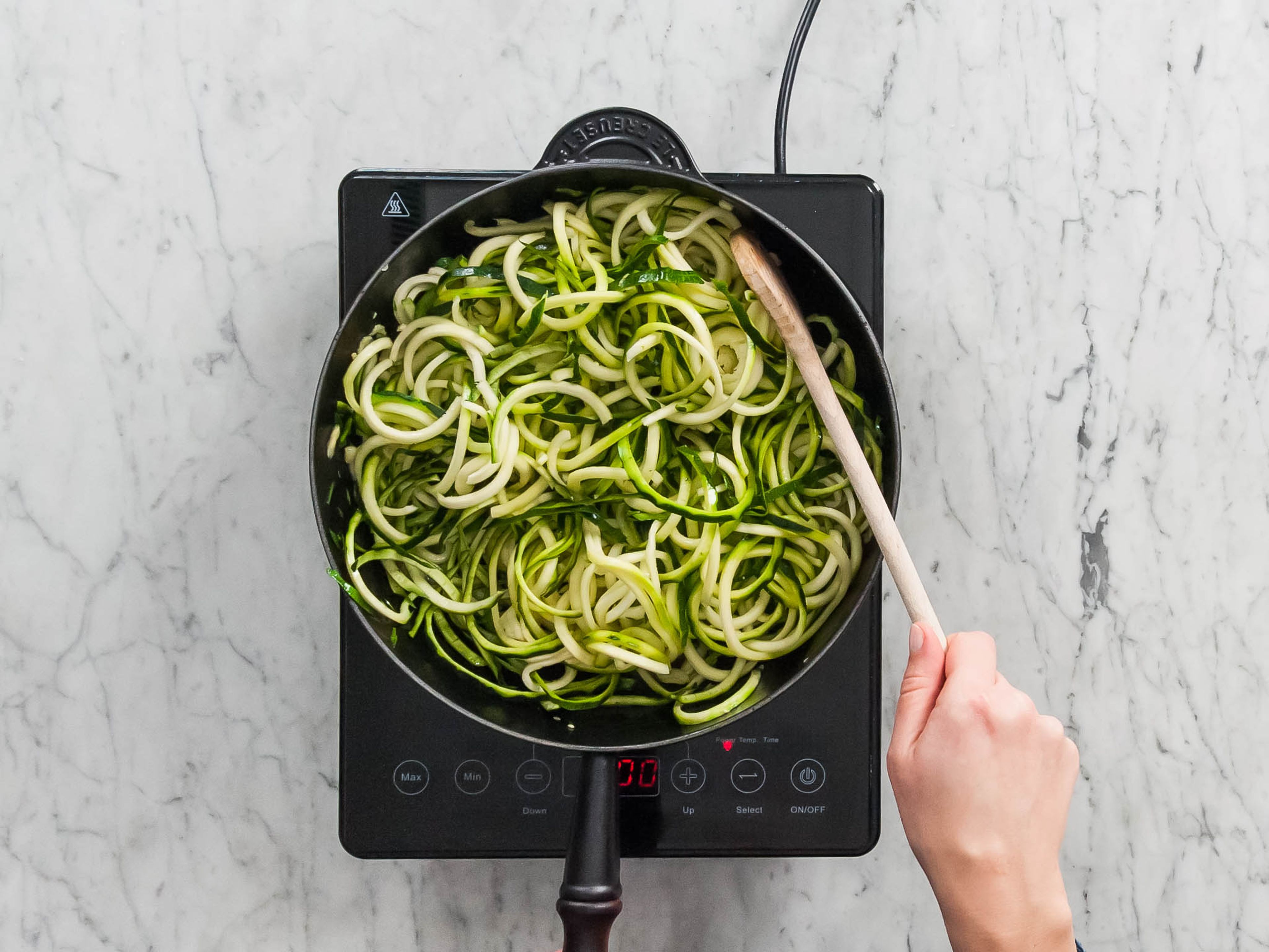 Heat oil in frying pan over medium-high heat; add zucchini and cook, stirring occasionally, for 2 – 3 min., or until softened. Add cauliflower Alfredo sauce and toss gently to coat. Season with salt and pepper if desired. Top with additional cheese and parsley for serving. Enjoy!