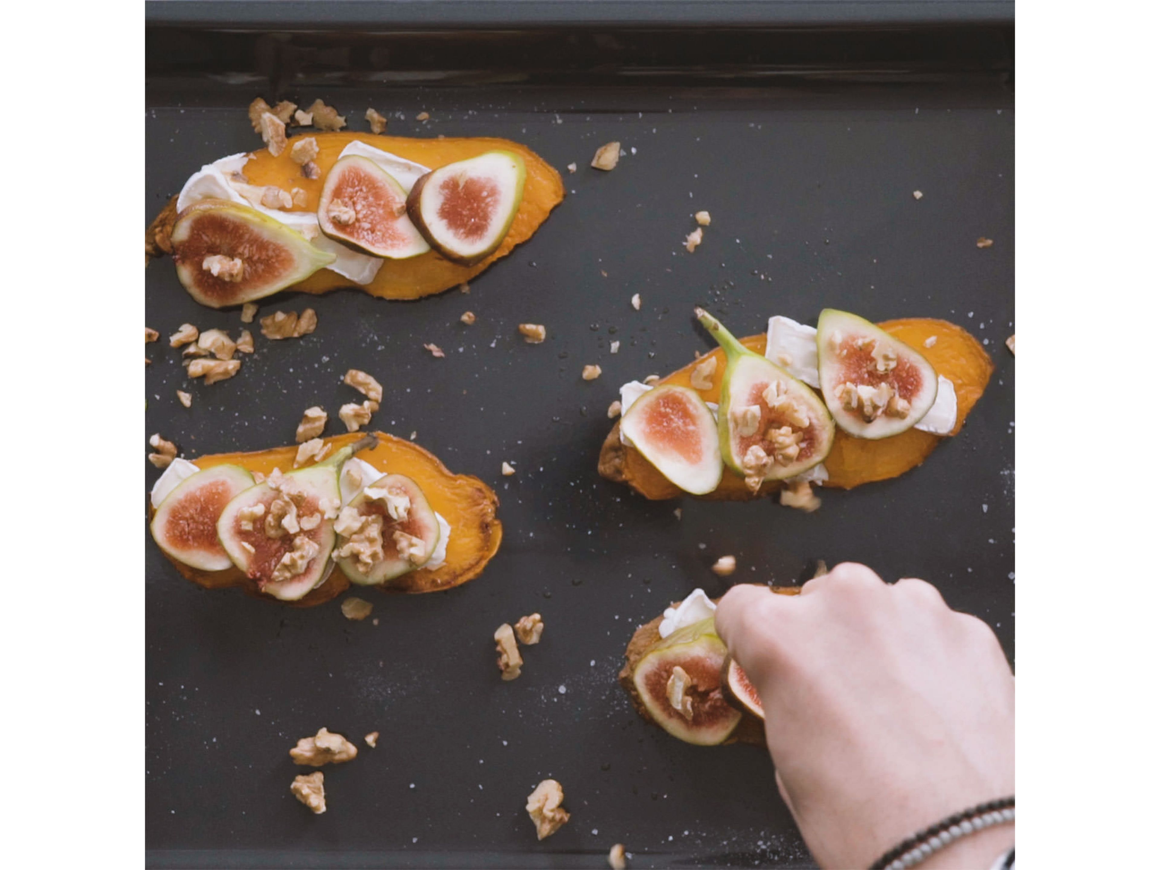 Cut goat cheese and figs into thin slices. While sweet potato slices are still hot, top with sliced goat cheese, figs, and walnuts. Return to oven and bake at 200°C/390°F for approx. 8 min., or until cheese is melted.