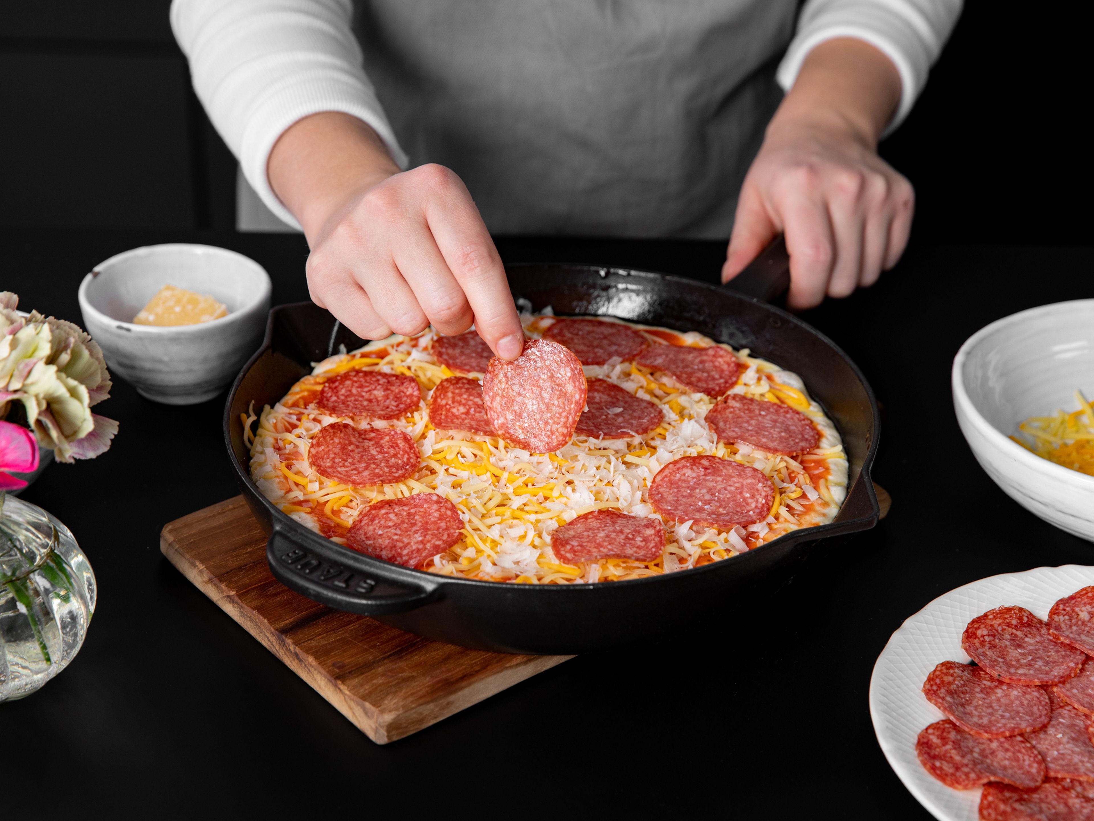 Top pizza dough with half the tomato sauce, half the cheese, and half the pepperoni. Bake in a preheated oven at 250°C/475°F for approx. 10 min. Remove from the oven and serve immediately. Repeat the process to use up remaining dough and toppings. Enjoy!