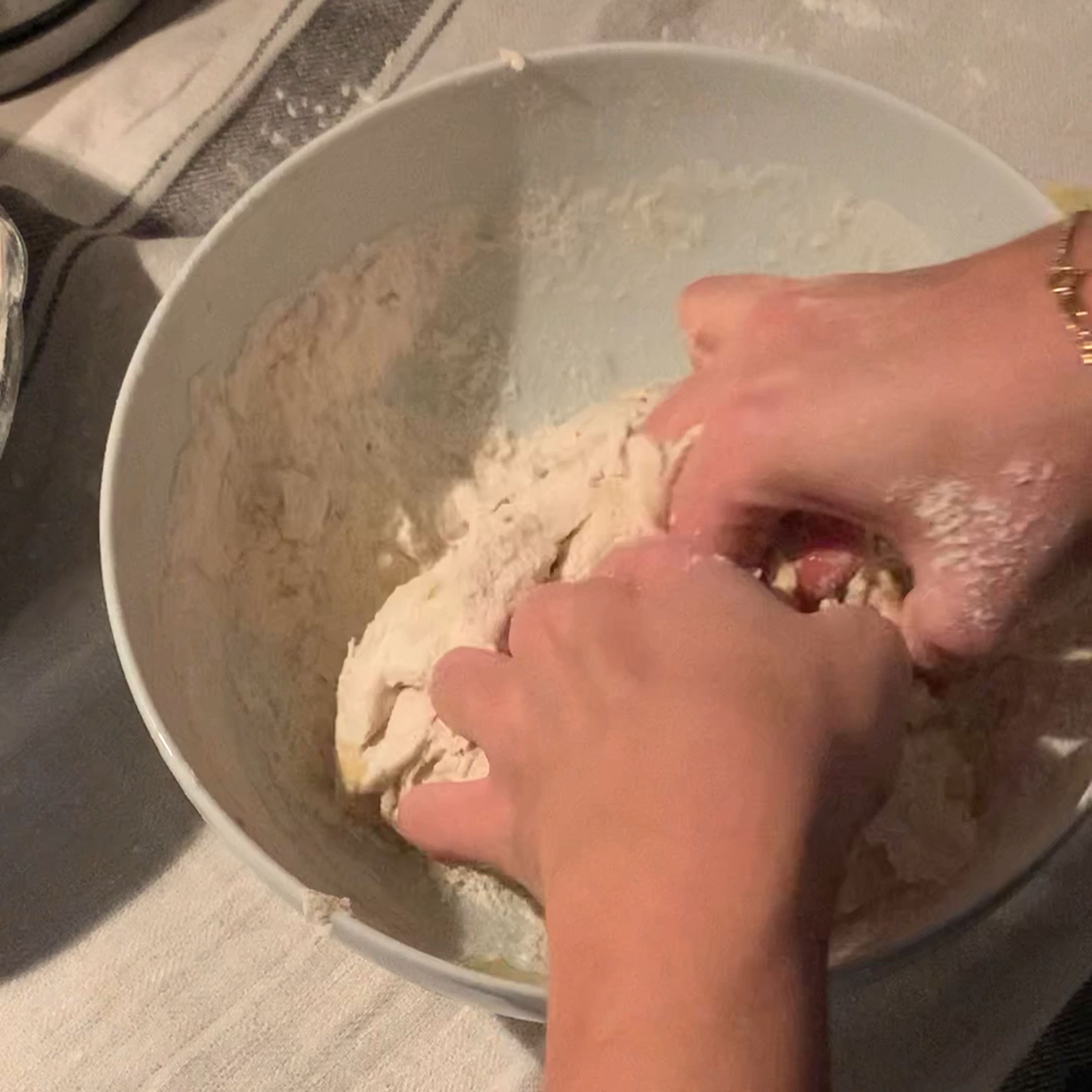 When all the flour is added, start kneading the dough with your hands.