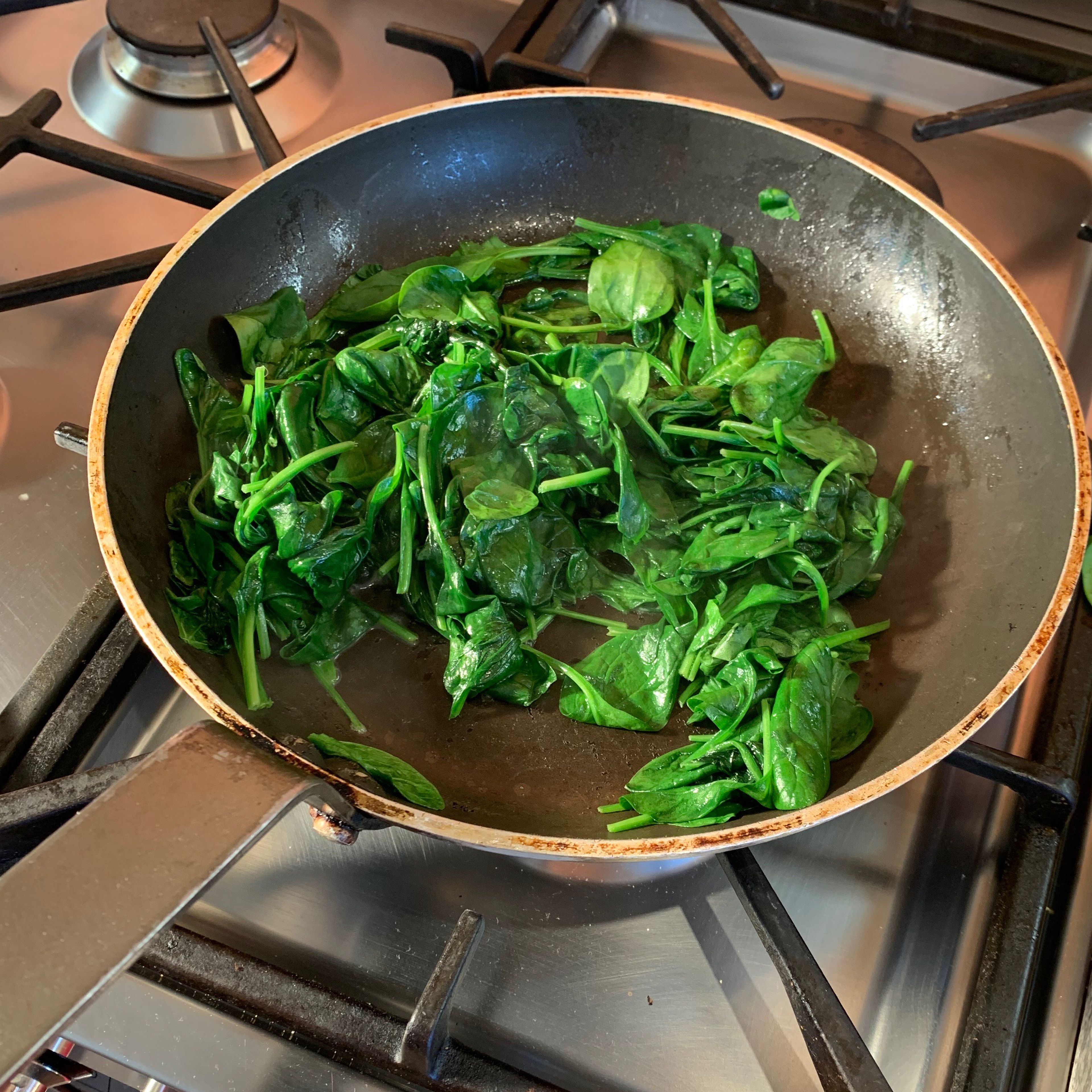 Melt the butter in a frying pan over a medium heat and then add the spinach and the grated nutmeg. Cook until wilted