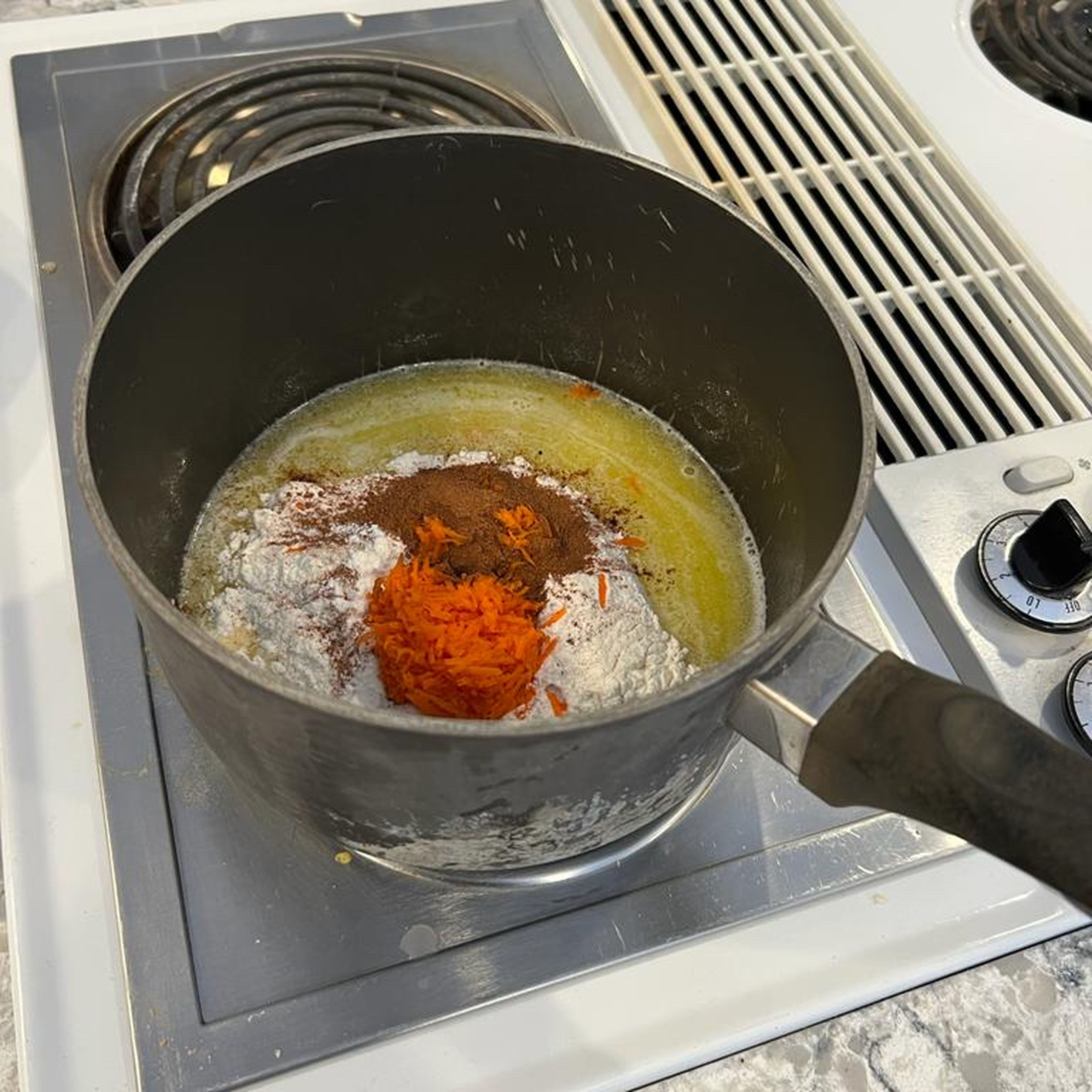 Take the pan off the heat and combine flour, your spices, and carrots into the pan mixture. Put back on the heat and cook for 1-3 more minutes while mixing constantly.